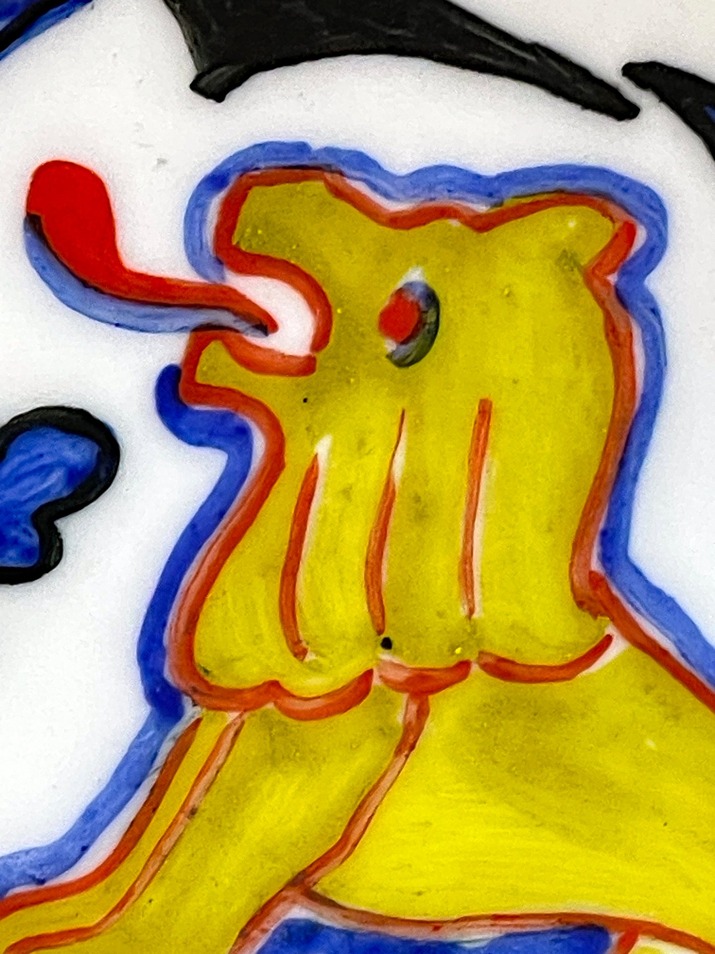 Detail of a reclining golden ox on the rim