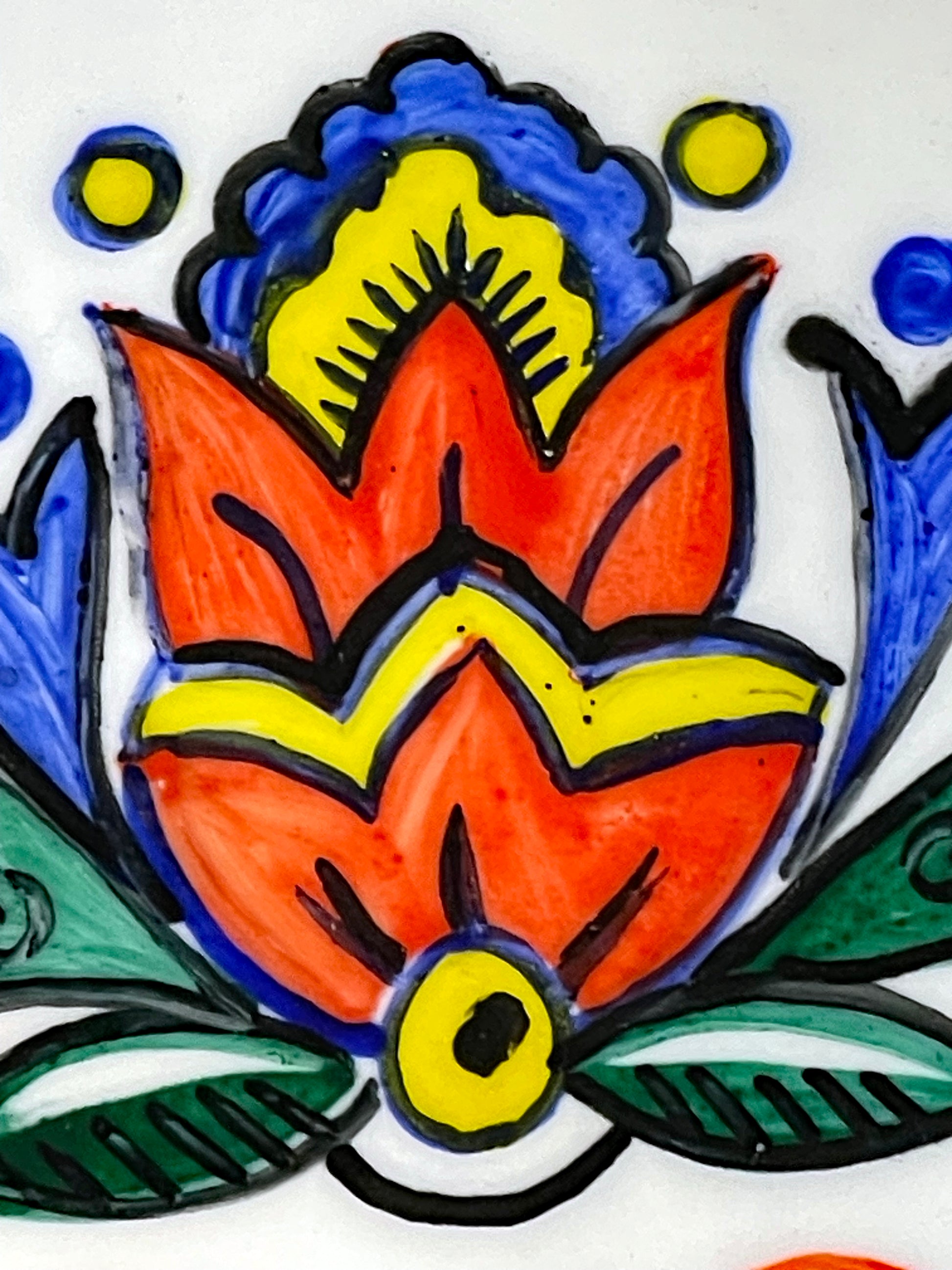 Detail of a scarlet and yellow stylised tulip blossom