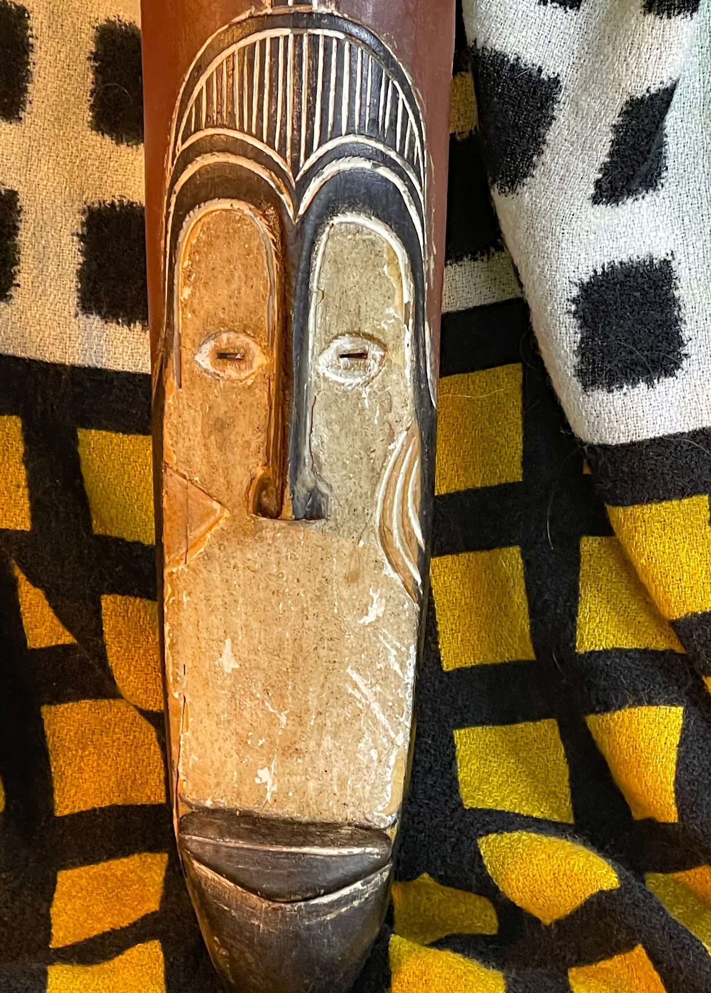 Close detail of the mask face showing kaolin white pigment and patina