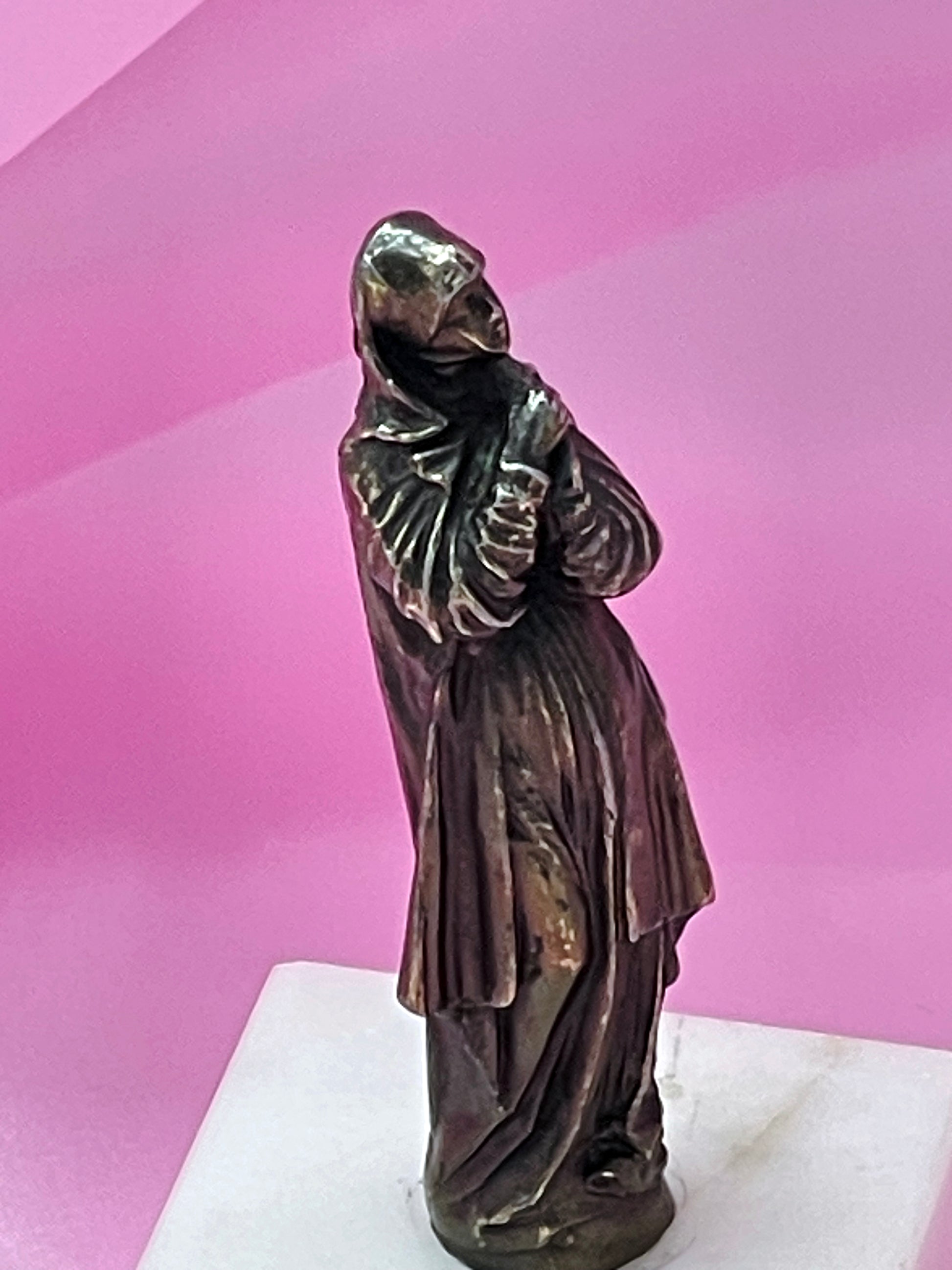 Patinated bronze Virgin Mary in prayer, angled view