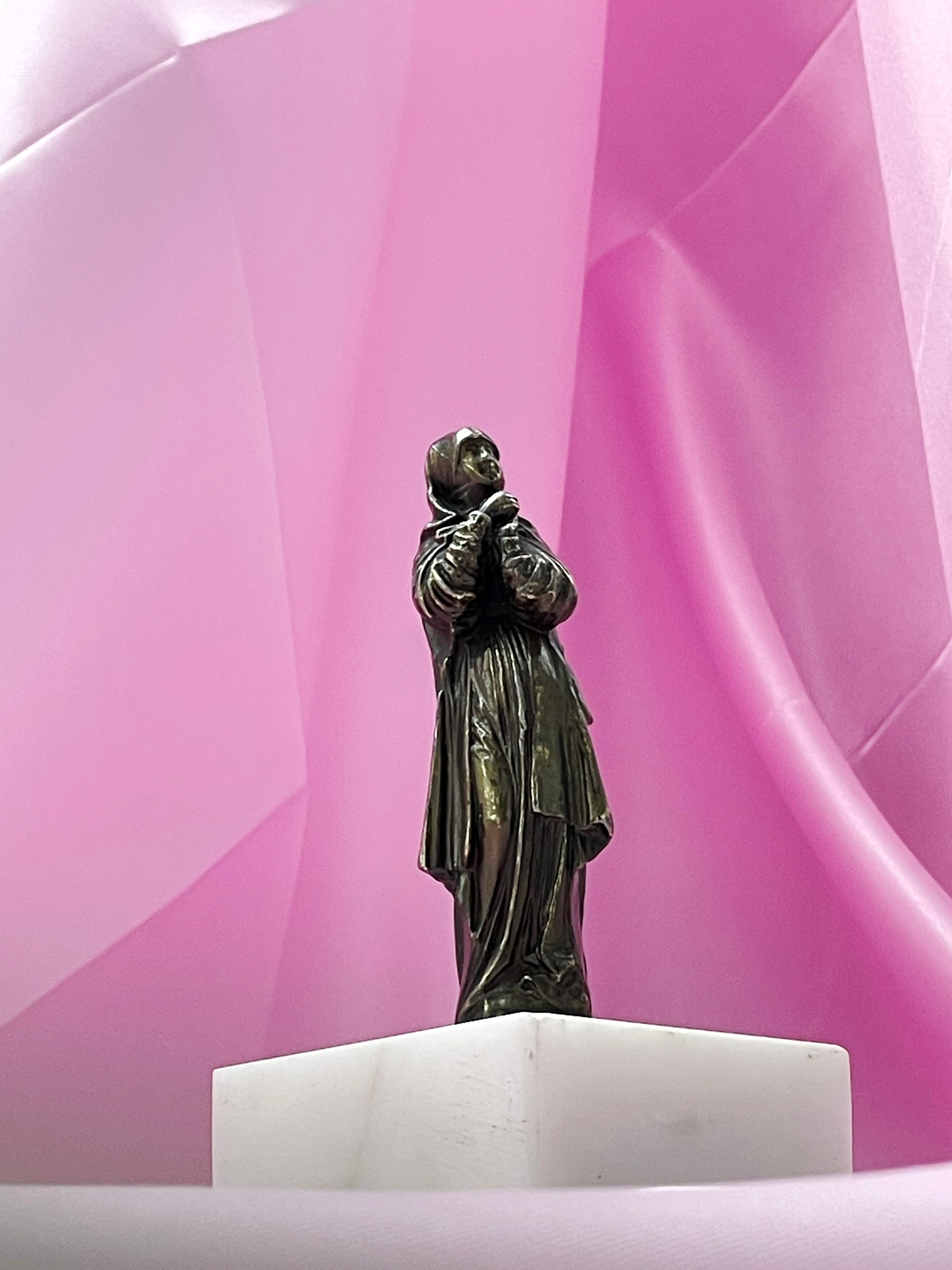 Antique bronze praying Virgin Mary figure on white marble base