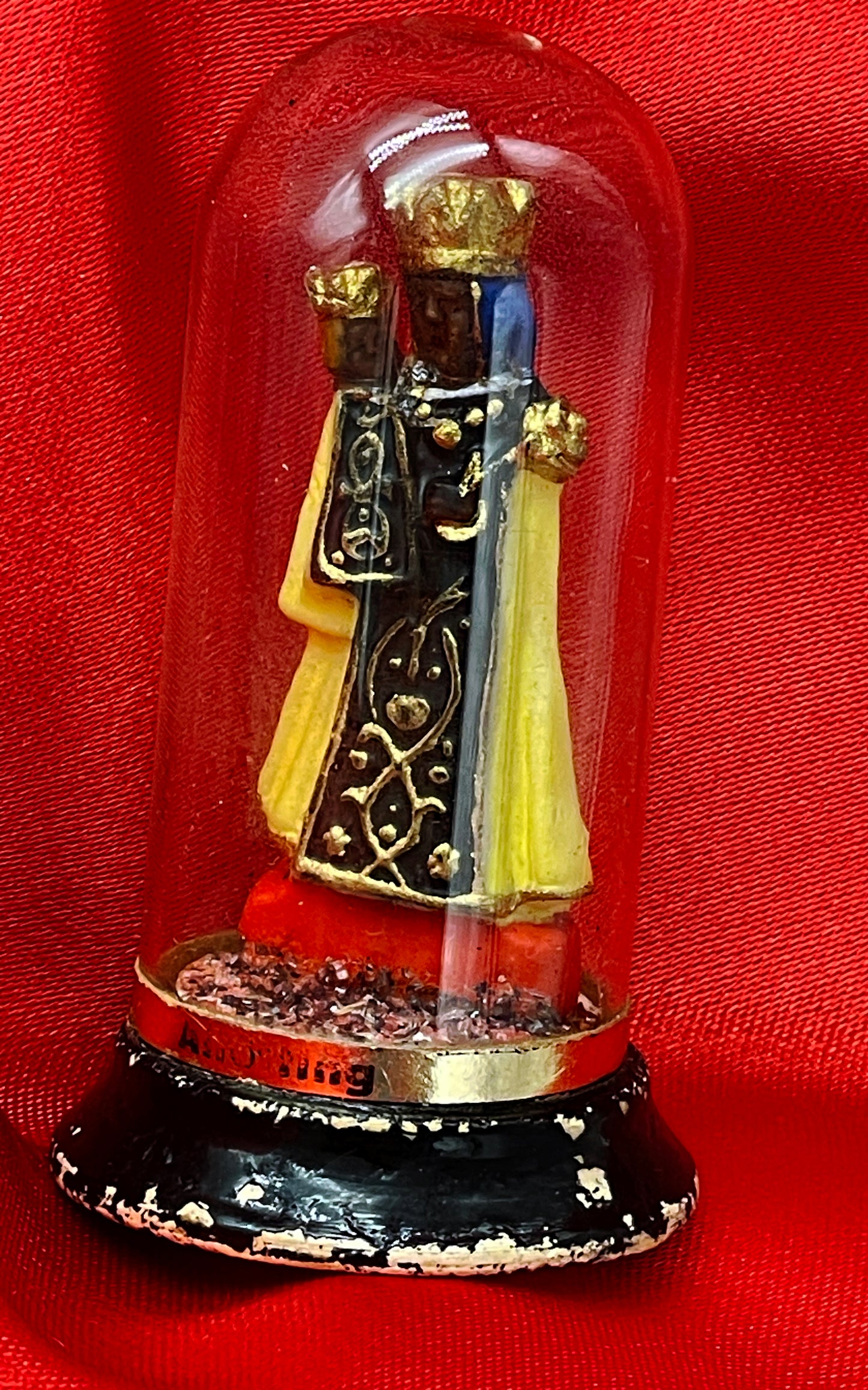 Black Madonna figure on wooden base front view