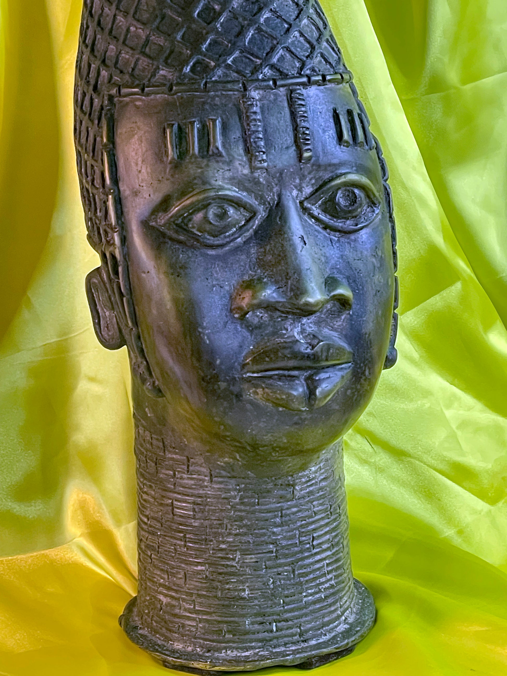 Front portrait of a vintage Benin bronze Queen Mother head with peaked coral bead crown