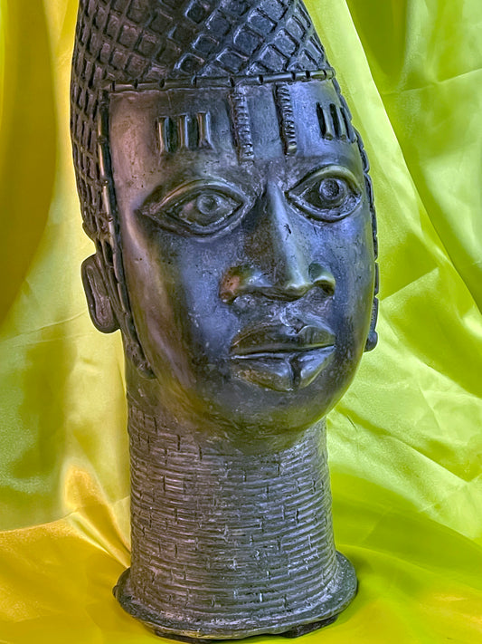 Front portrait of a vintage Benin bronze Queen Mother head with peaked coral bead crown
