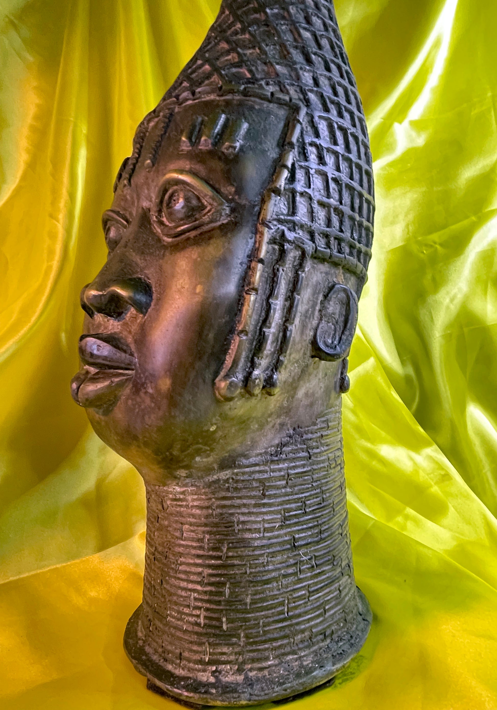 Three quarter view highlighting the beaded collar and scarification marks