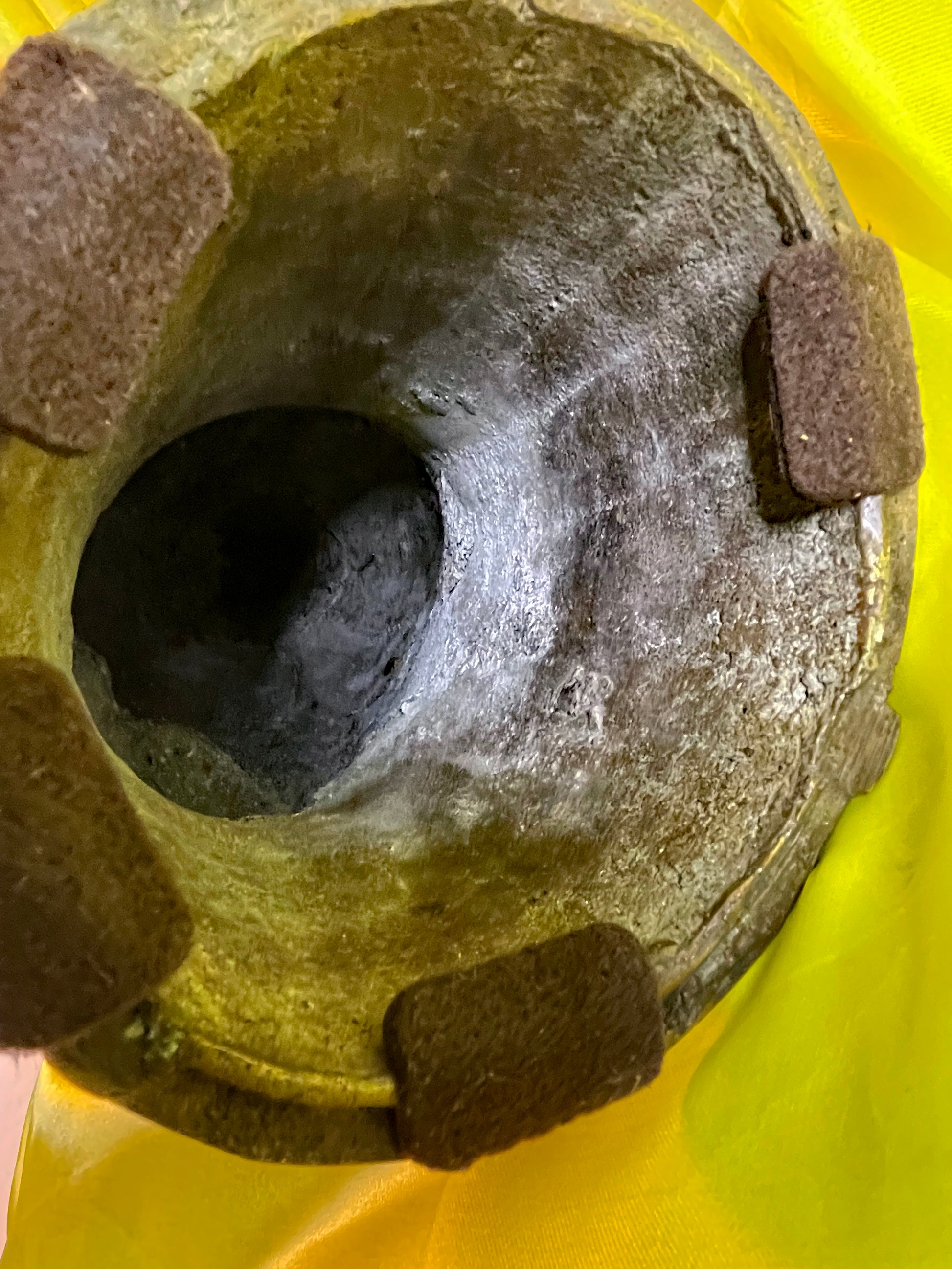View into the hollow cast base showing lost wax bronze construction