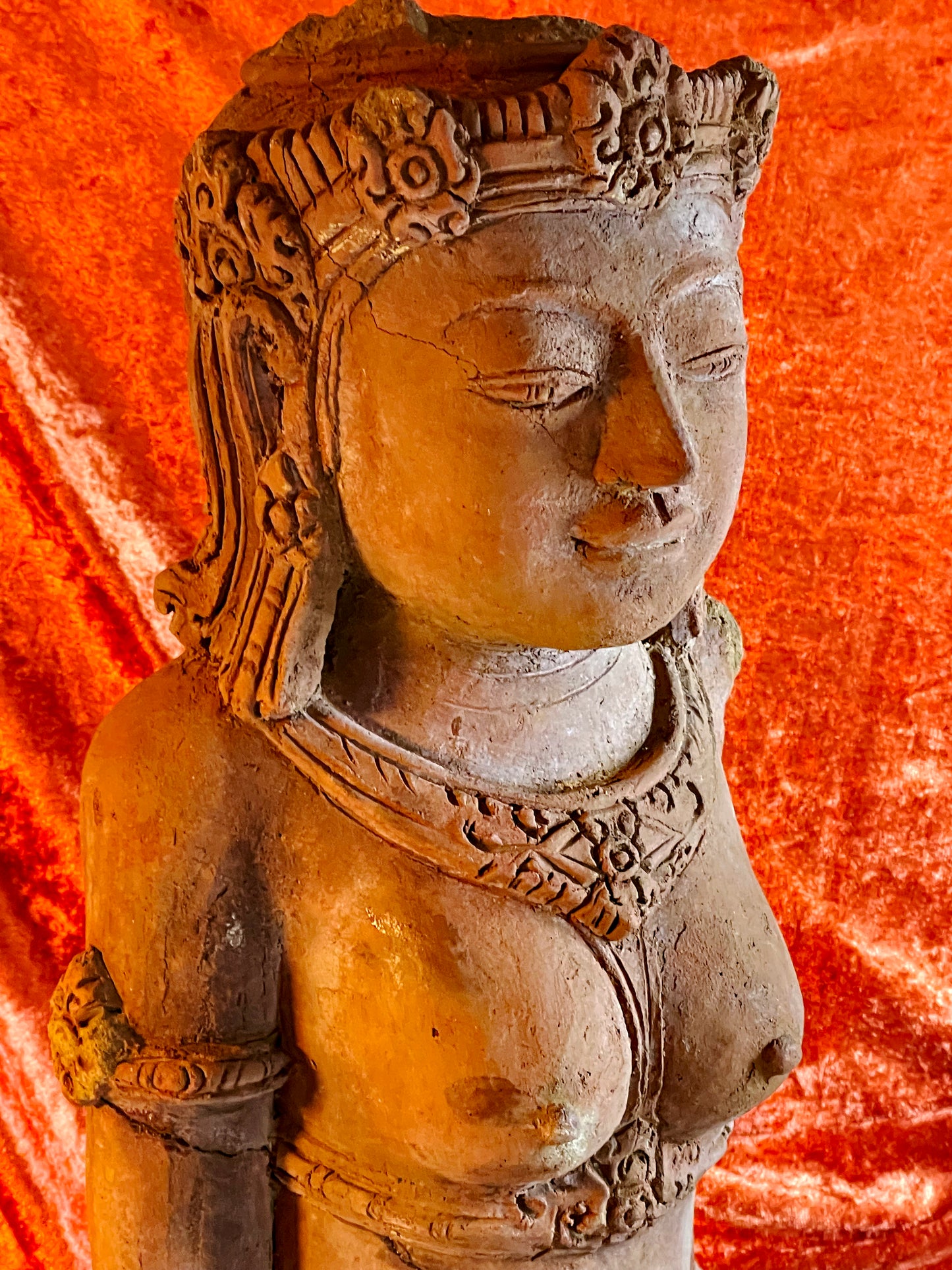 Terracotta goddess figure side view showing carved headdress