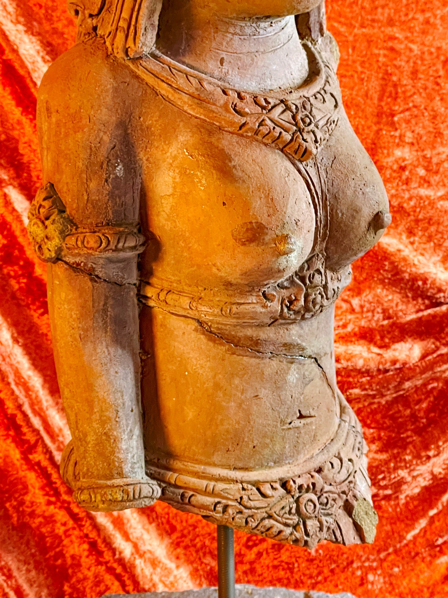 Detail of carved necklaces on antique terracotta temple figure