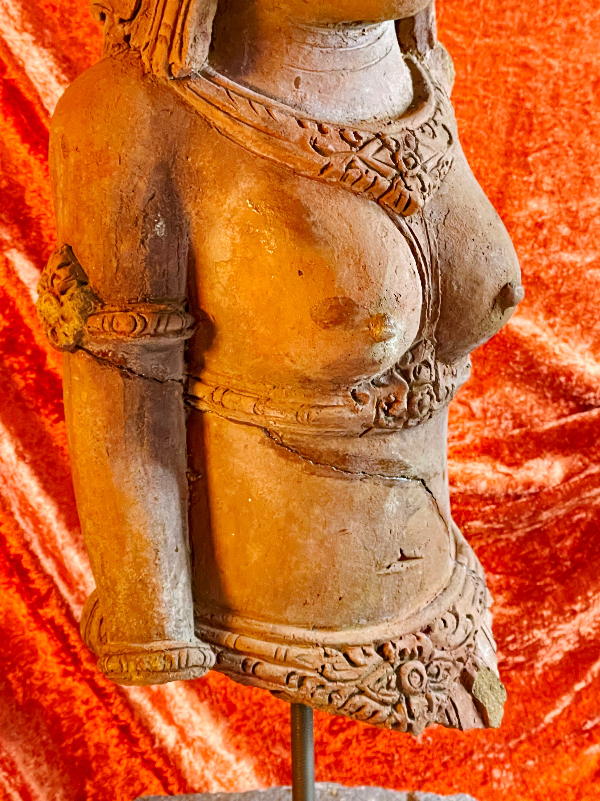 Detail of carved necklaces on antique terracotta temple figure