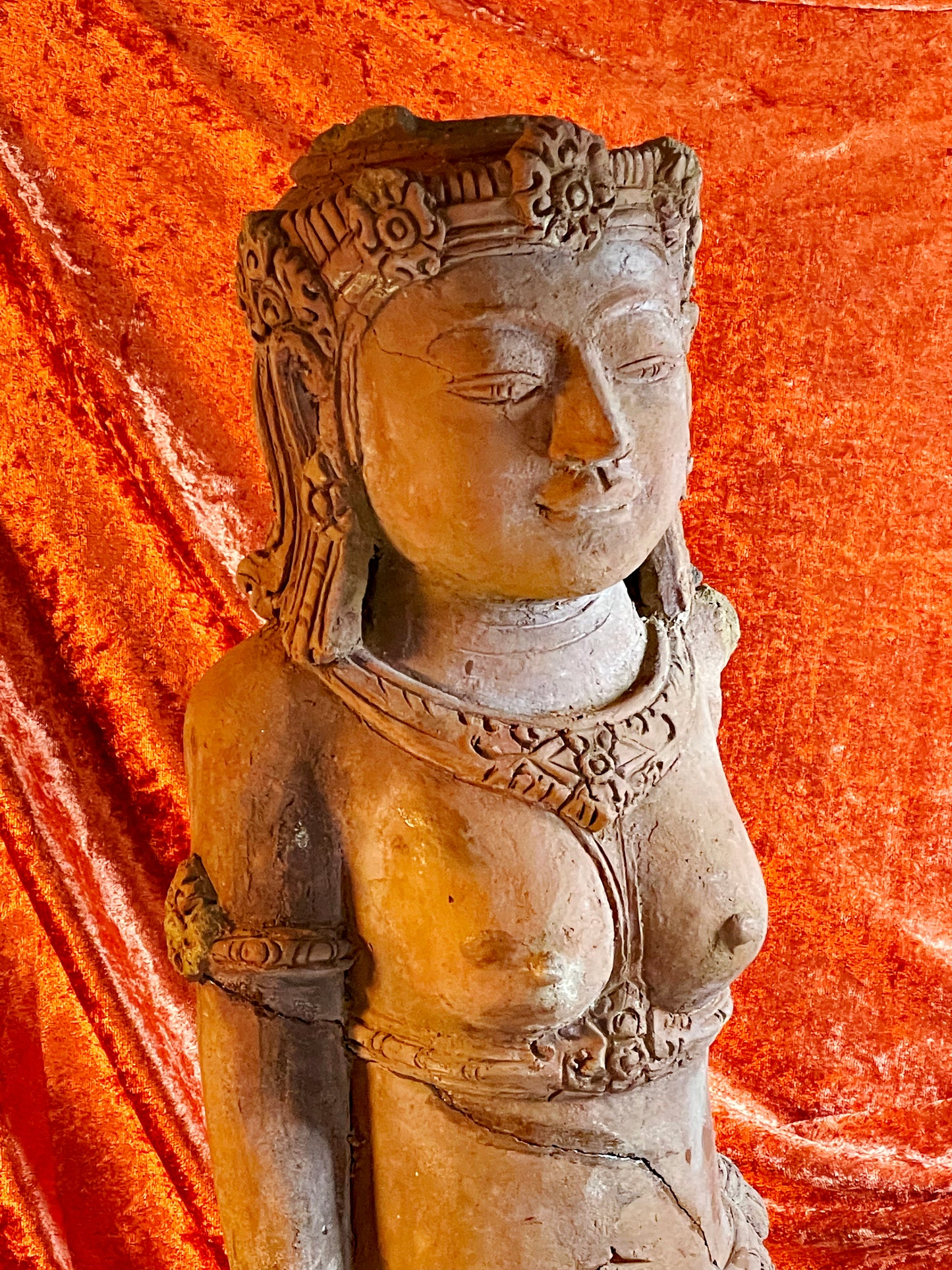Back view of antique terracotta temple goddess sculpture