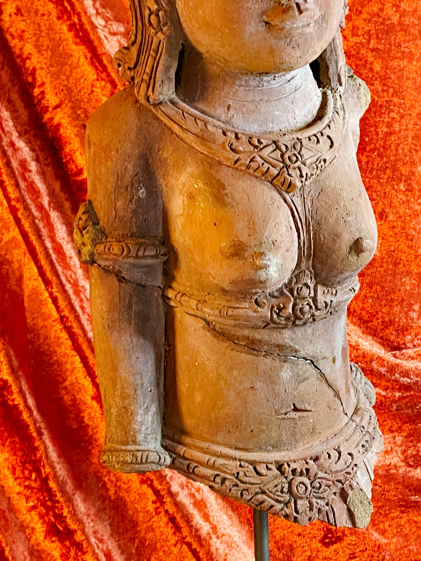 Hand-carved facial features of terracotta temple goddess