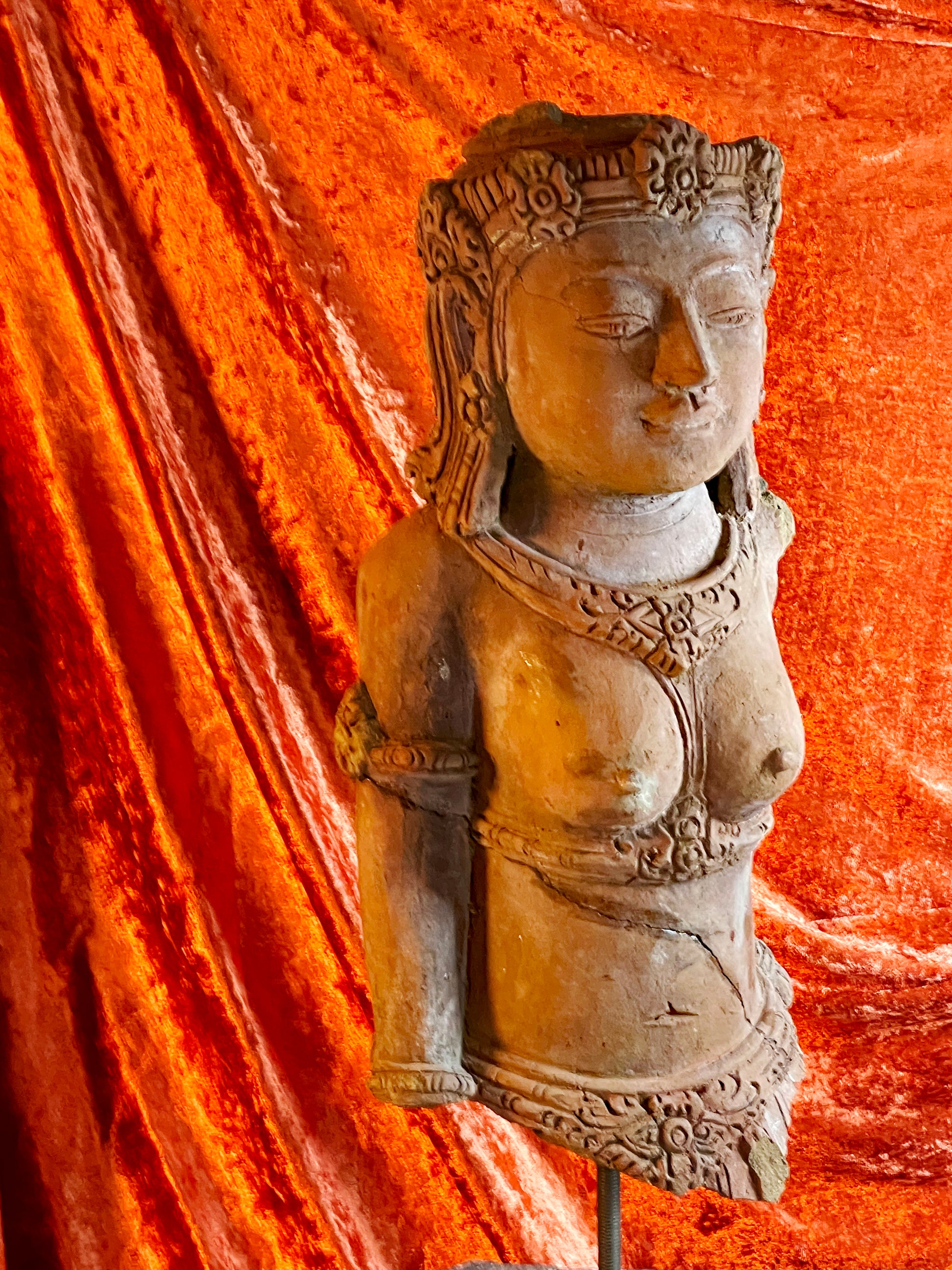 Antique terracotta temple figure with artisanal support stand