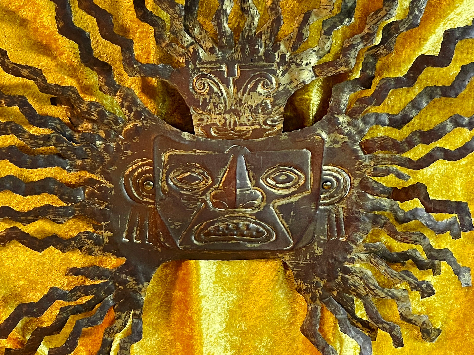 Brass Aztec Maya sun god wall mask with radiating rays on gold velvet