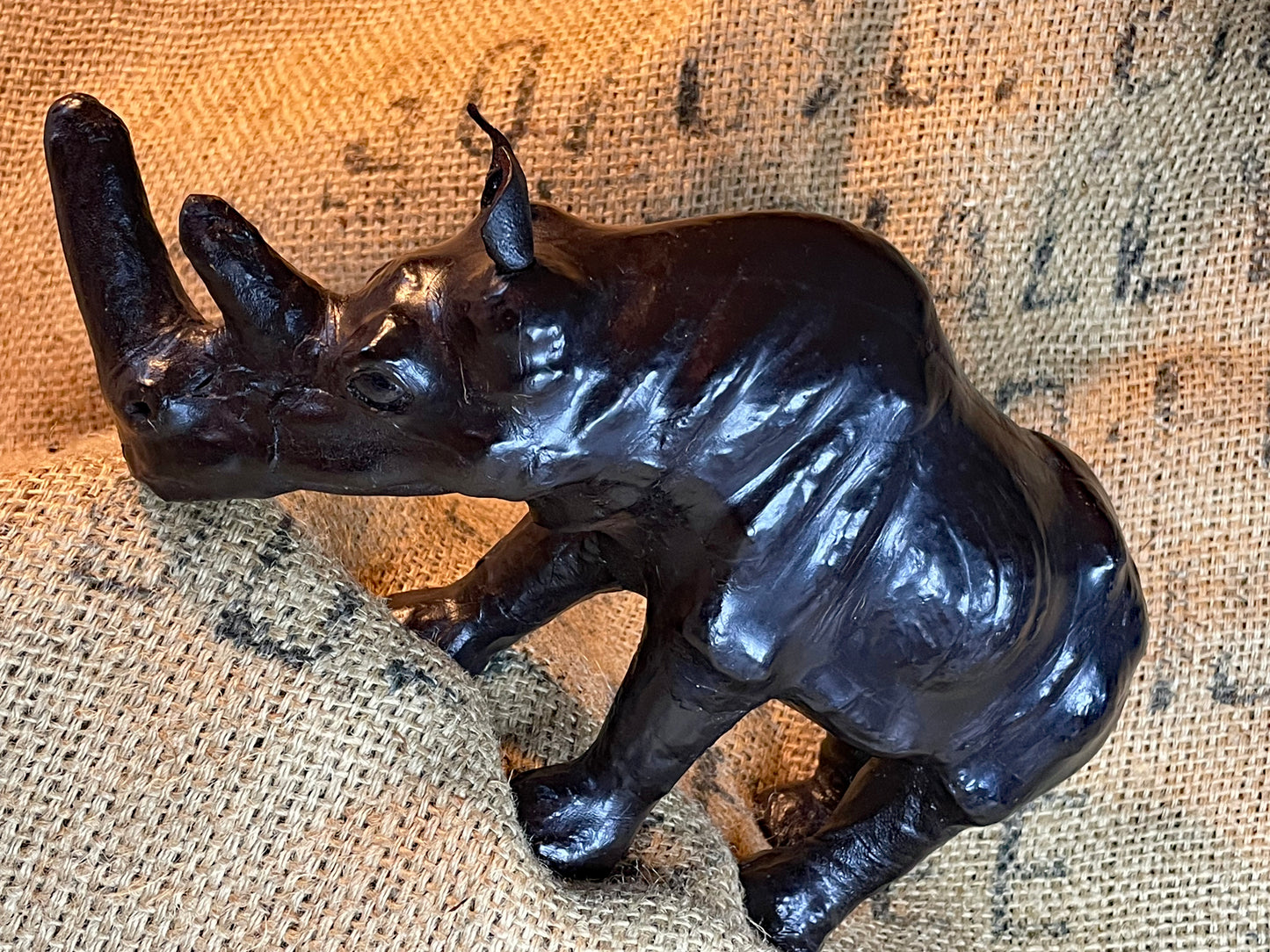 Three-quarter view of the leather rhino showing the double horn and form