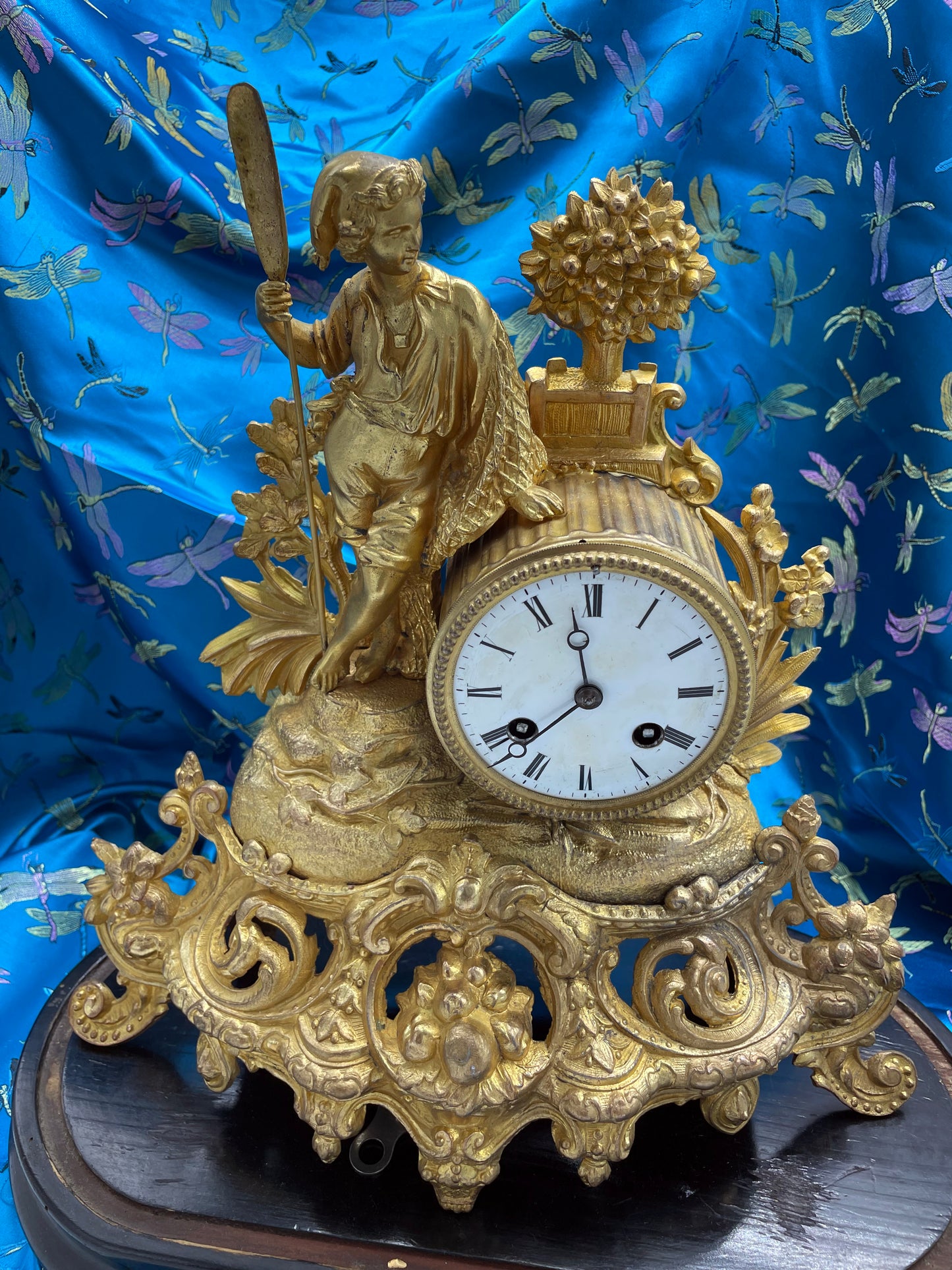 White enamel dial with Roman numerals on ormolu clock