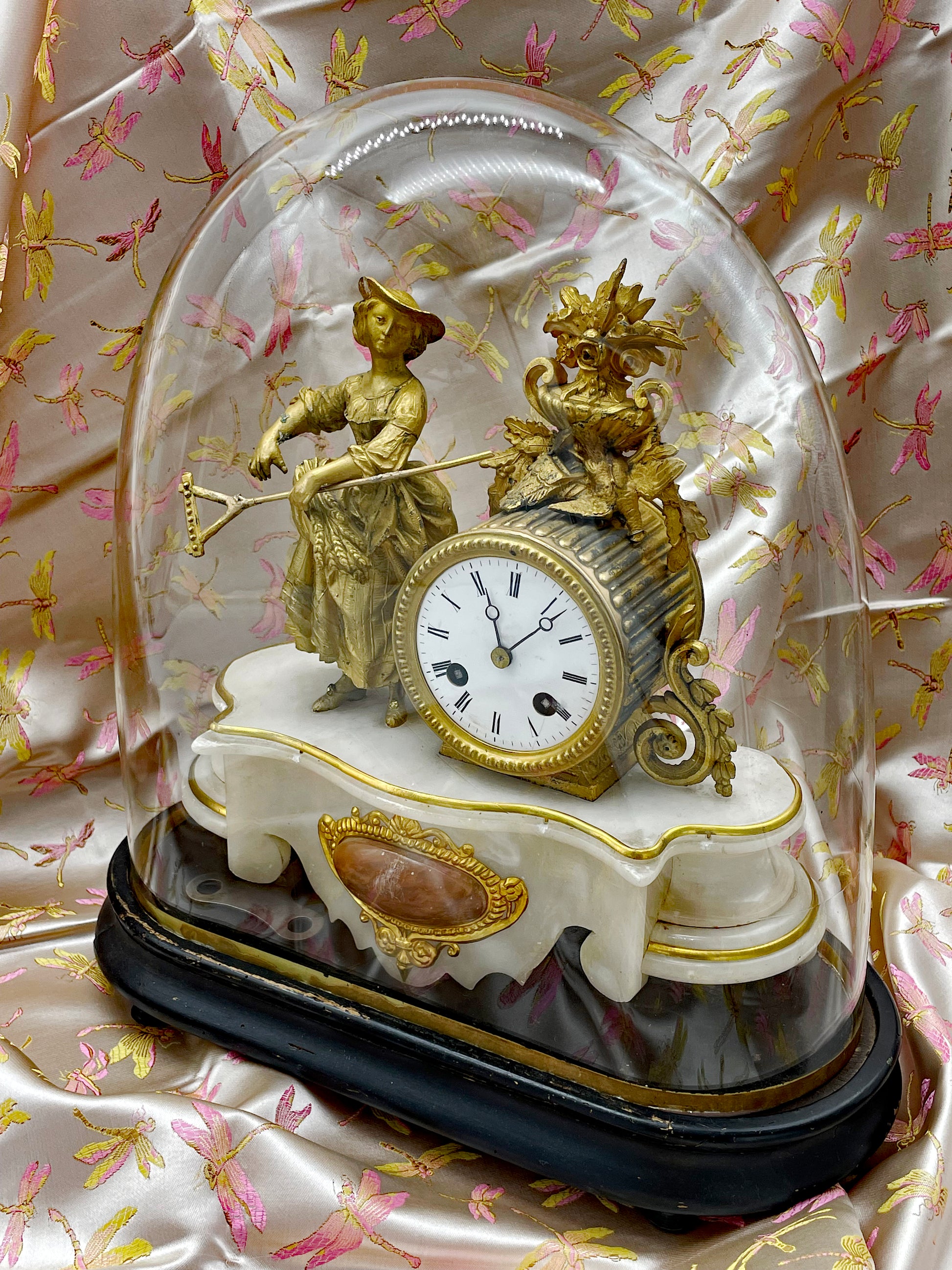 Antique French figural mantel clock under a glass dome, white marble base with fire-gilt bronze maiden, 19th century