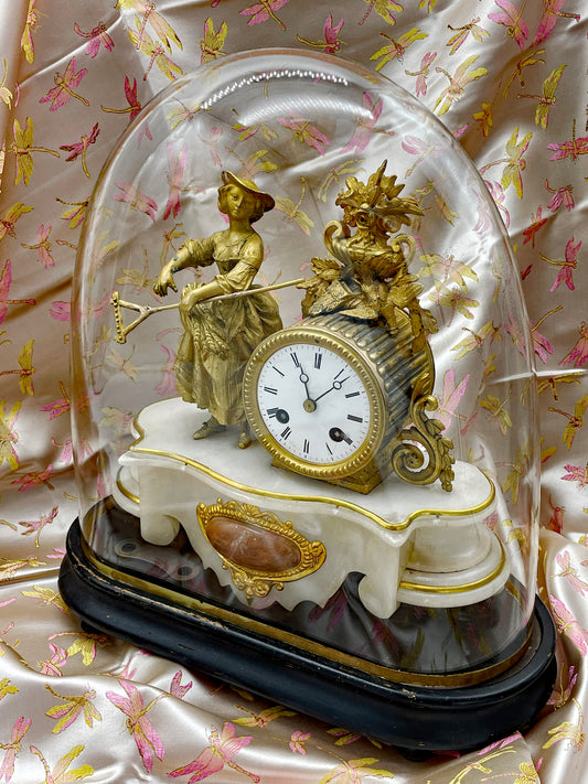 Antique French figural mantel clock under a glass dome, white marble base with fire-gilt bronze maiden, 19th century