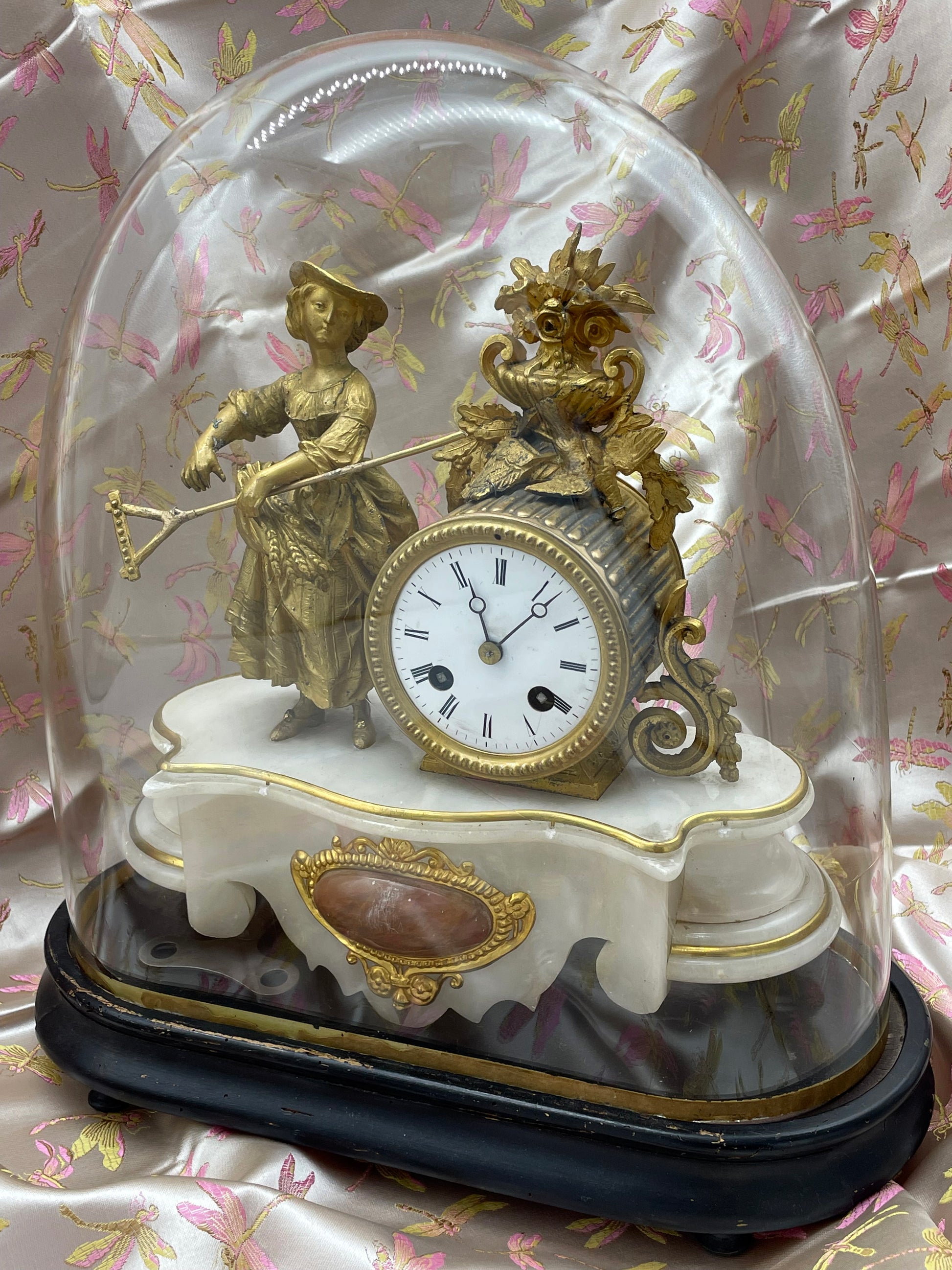 Fire-gilt ormolu figure of a seated lady beside the enamel clock dial