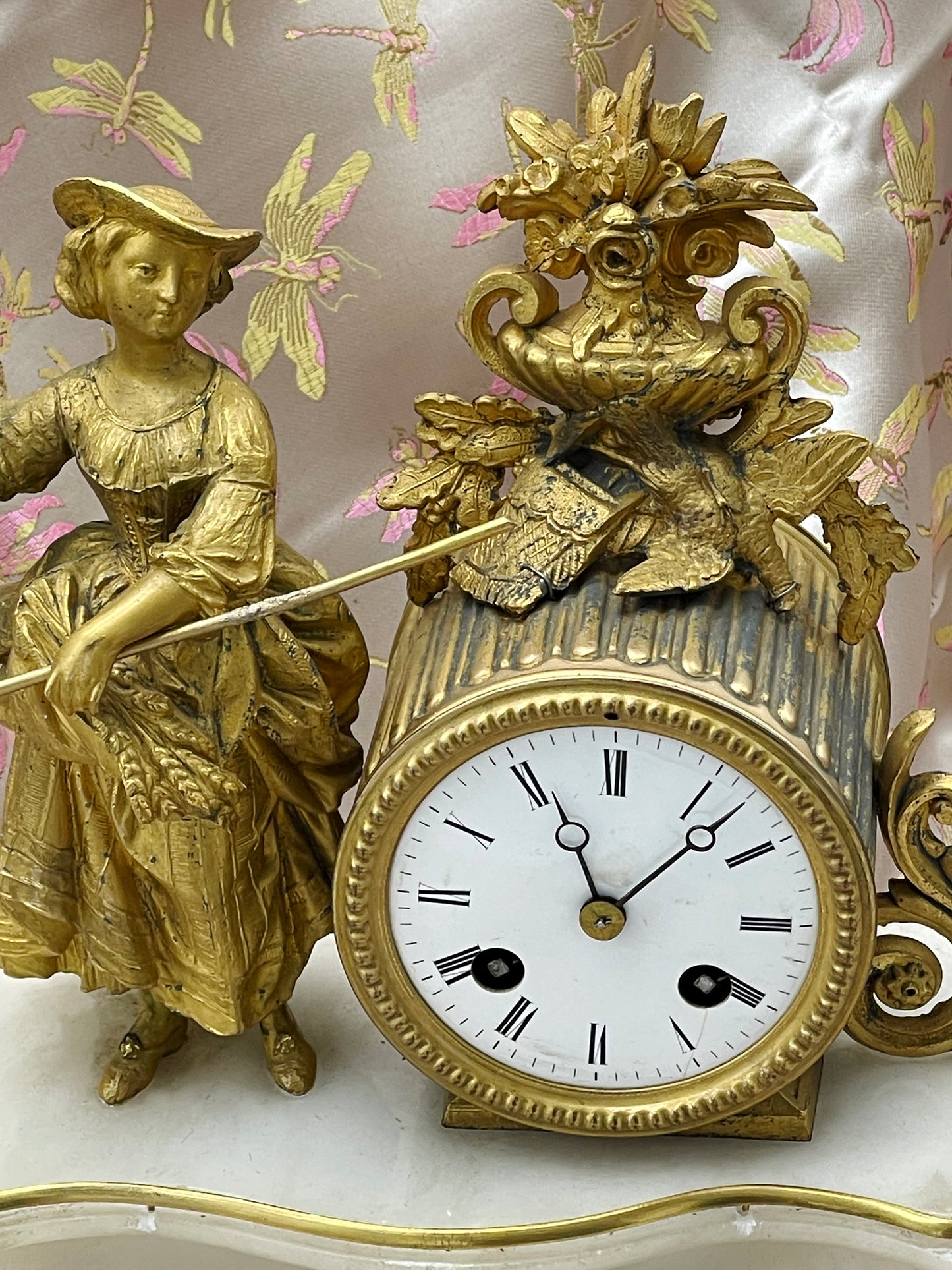 Side view of the white marble base of the French mantel clock