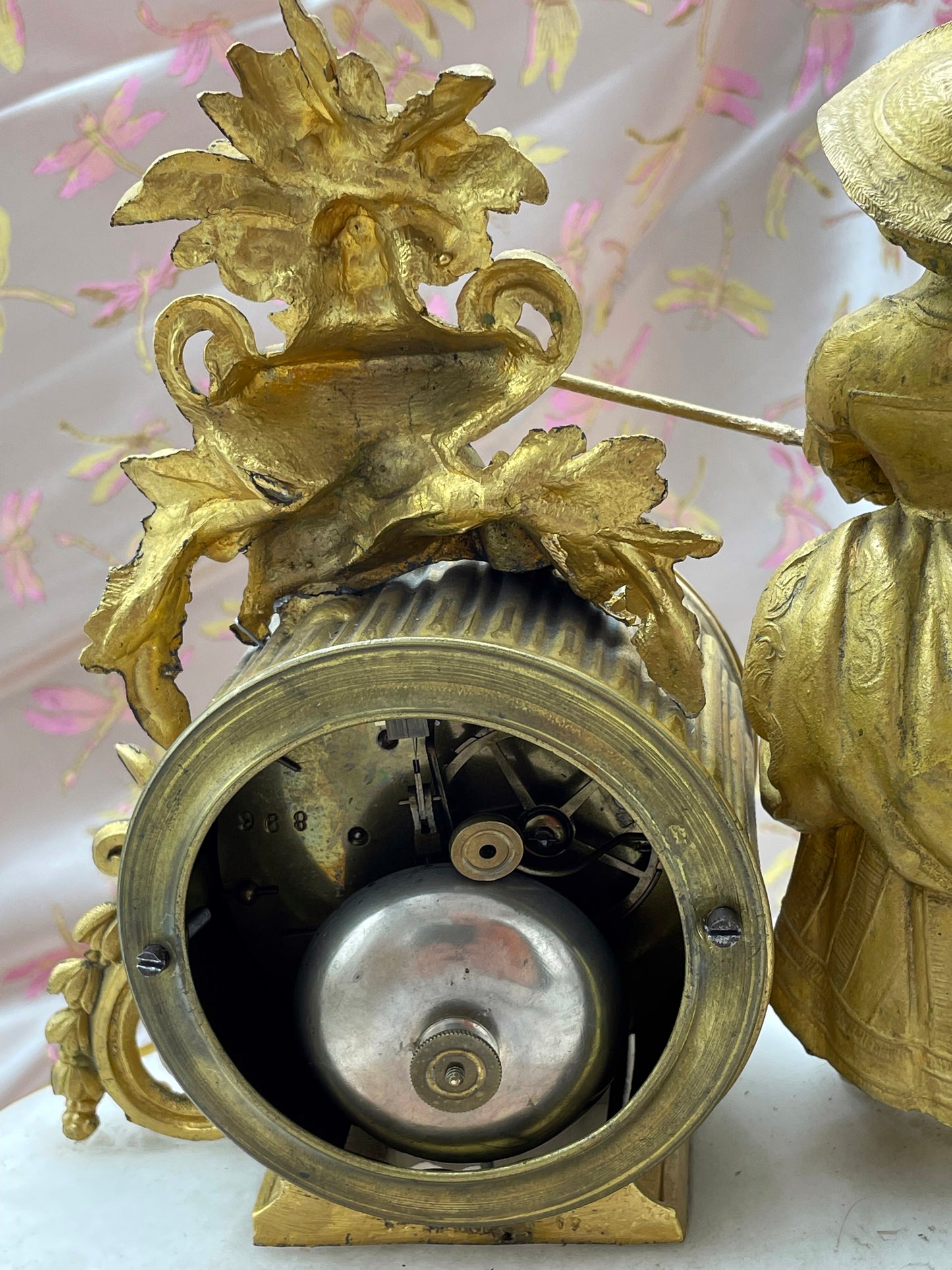 Overall view of the working antique French pendule under glass