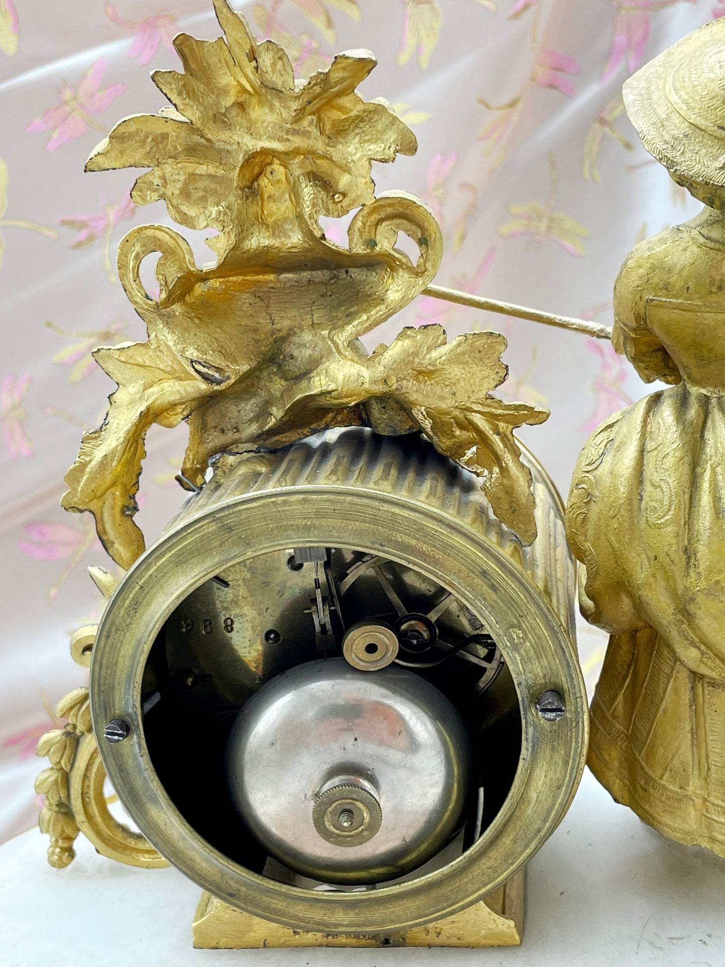 Rear view of the clock movement and mechanism with flowering ormolu urn