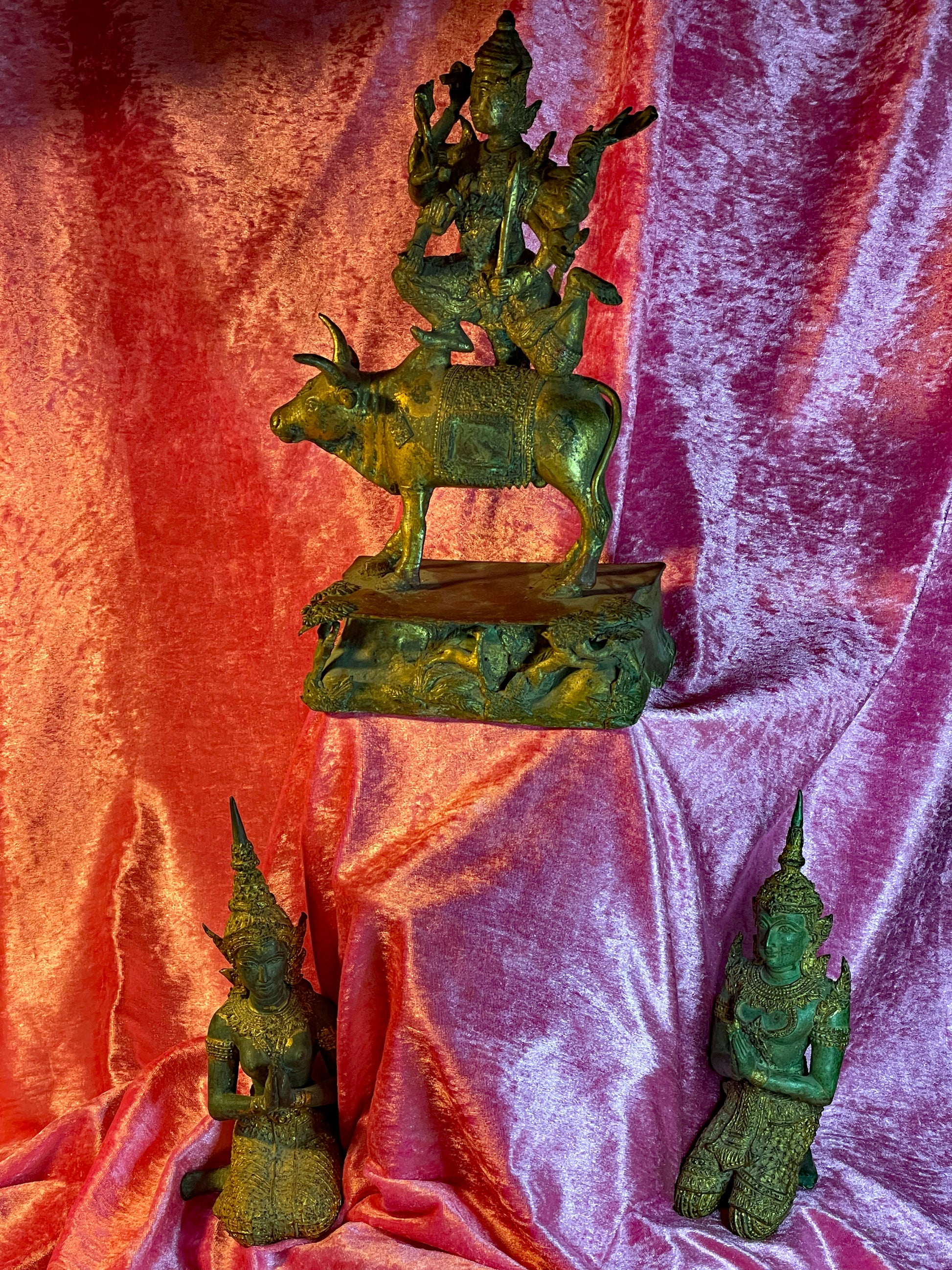 Thai gilt bronze group with Shiva on Nandi and two Teppanom temple guardians on velvet
