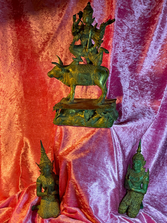 Thai gilt bronze group with Shiva on Nandi and two Teppanom temple guardians on velvet