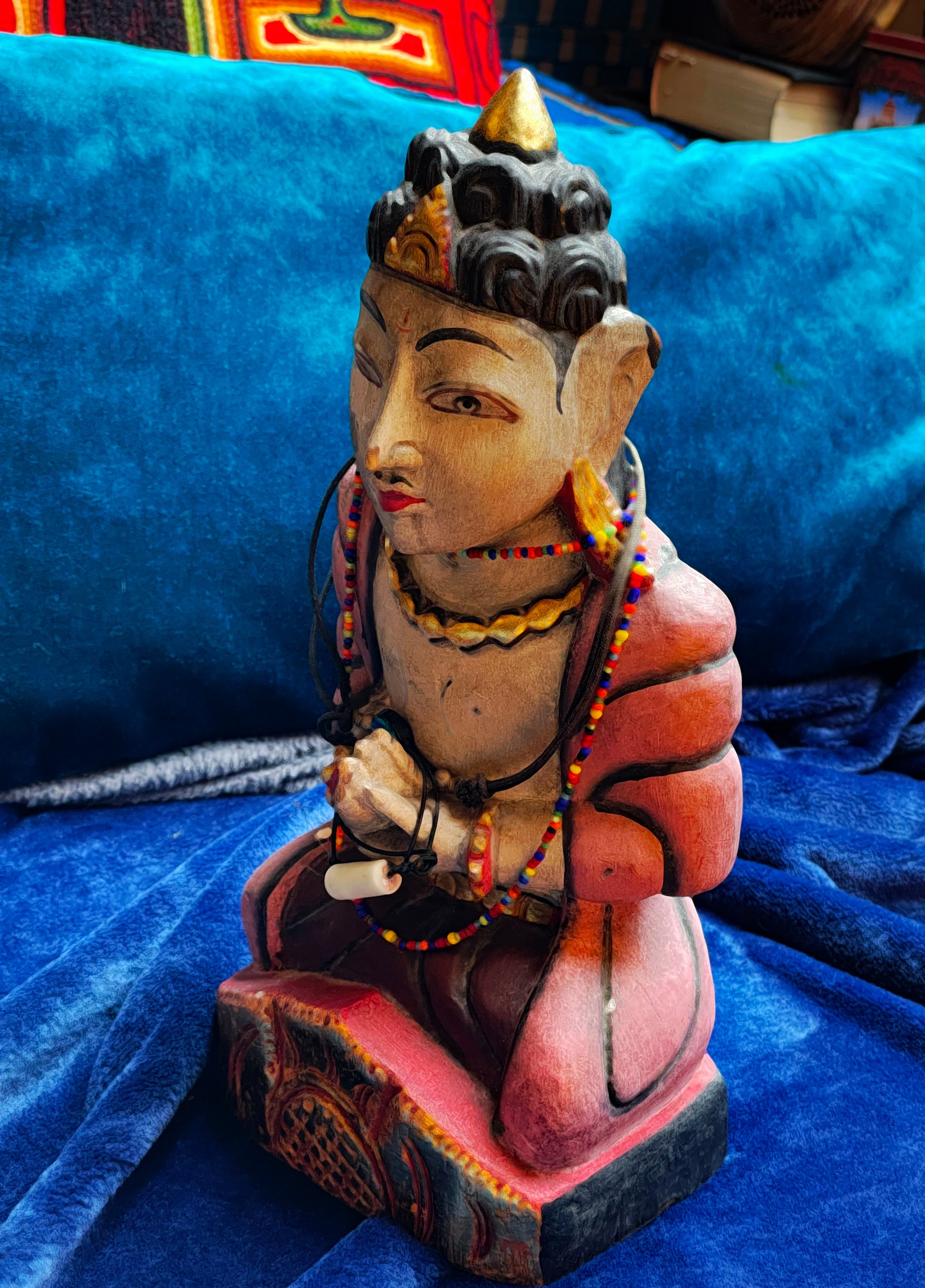 Side view of Indian hand-carved praying figure