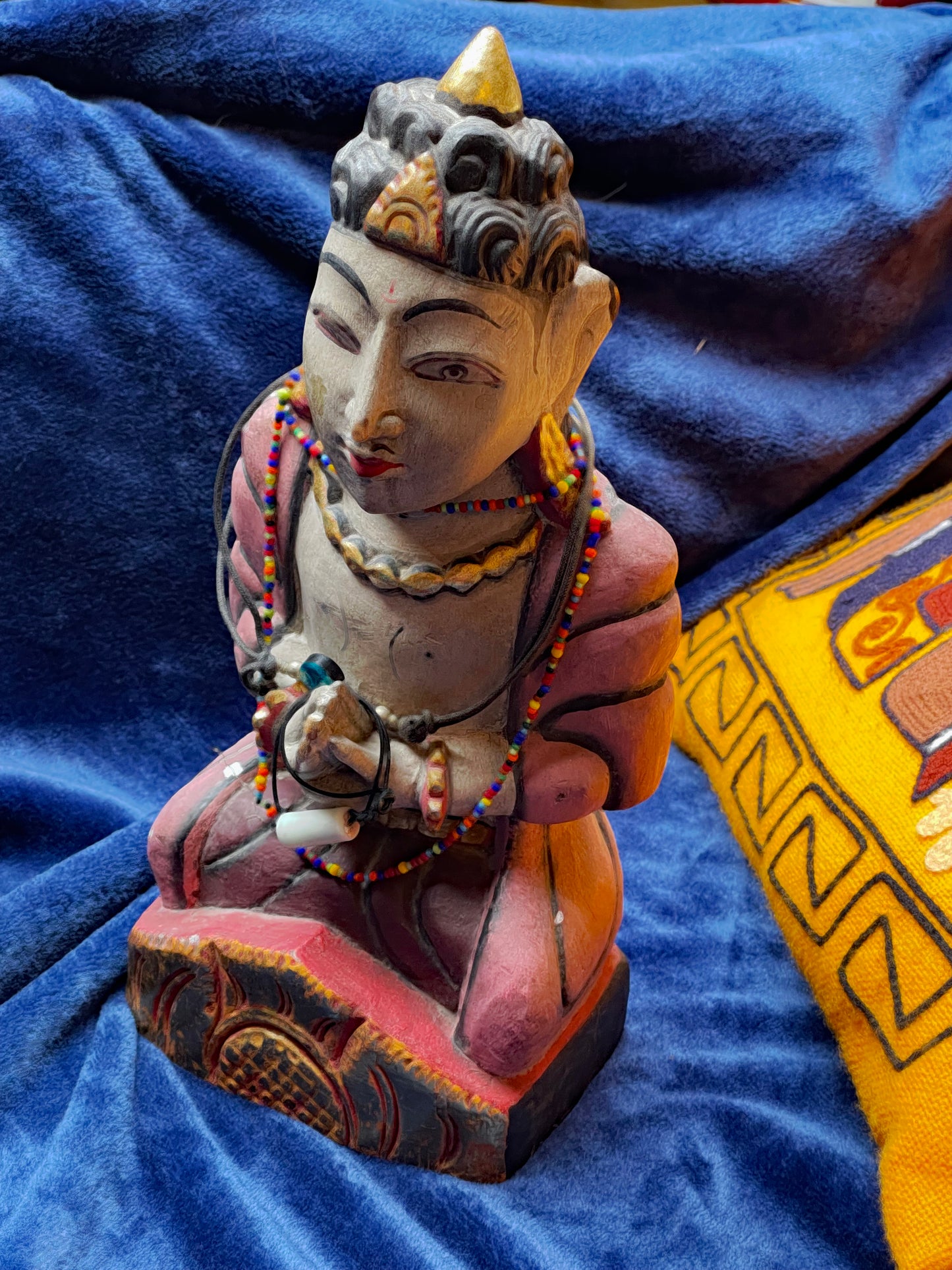 Detail of painted face and beaded necklaces