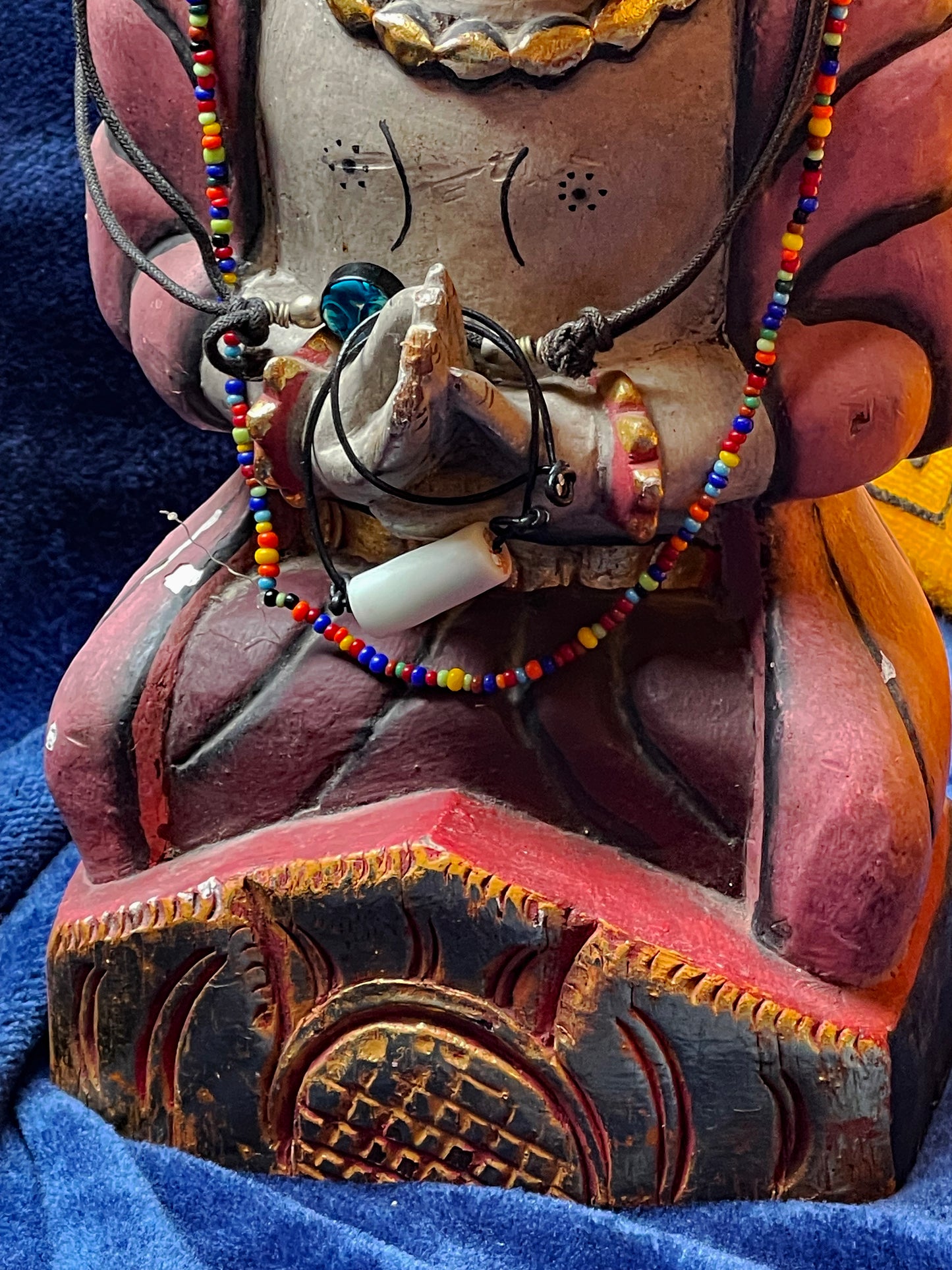 Back and base view of the carved wooden figure