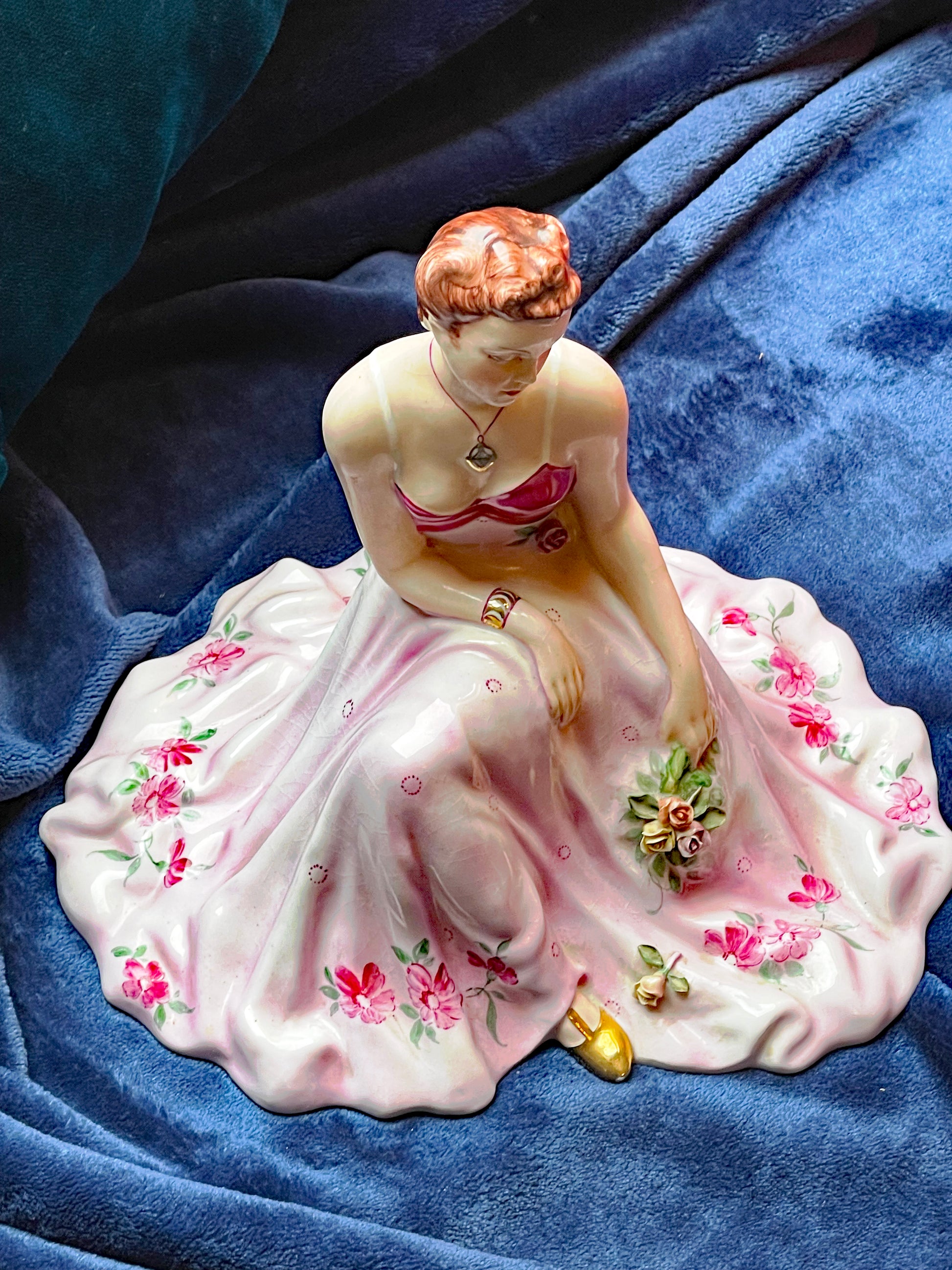 Vintage porcelain ballerina figurine with pink floral skirt