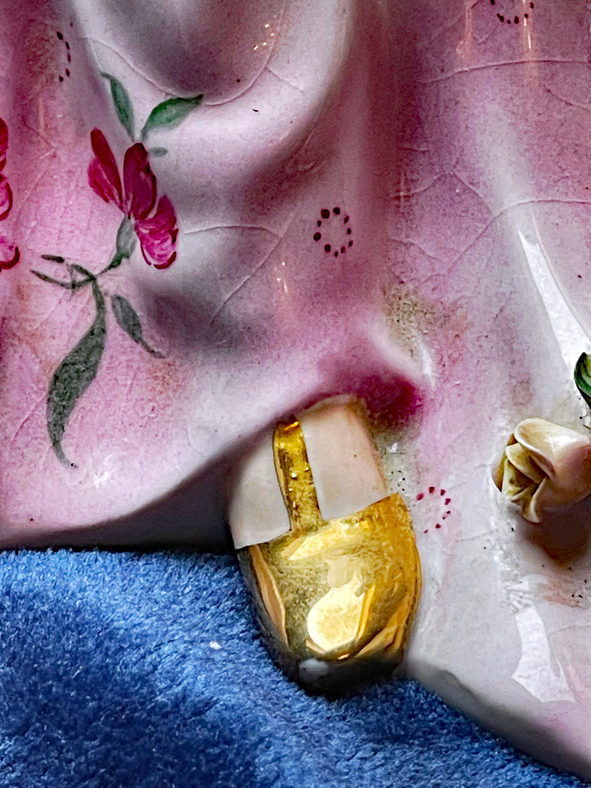 Close-up of porcelain dancer face and pendant