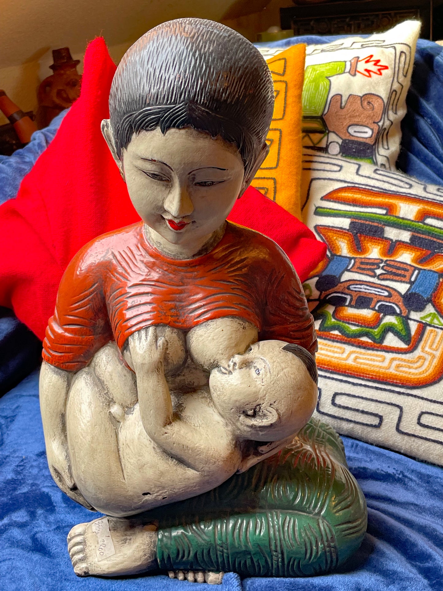 Side view of heavy mother and child wood sculpture