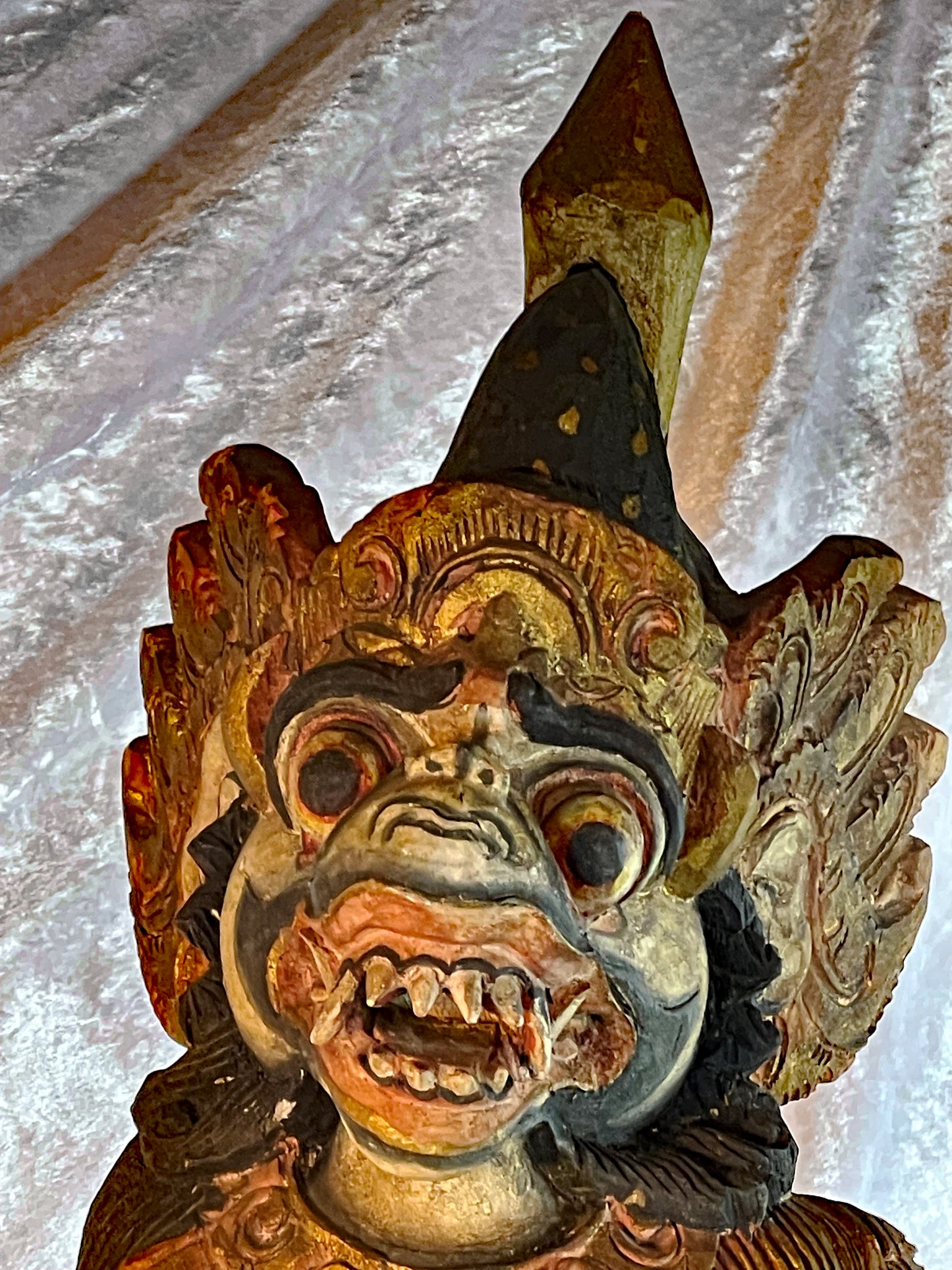 Balinese Hanuman statue, close-up of the expressive fanged monkey-god face and crown