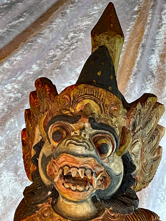 Balinese Hanuman statue, close-up of the expressive fanged monkey-god face and crown