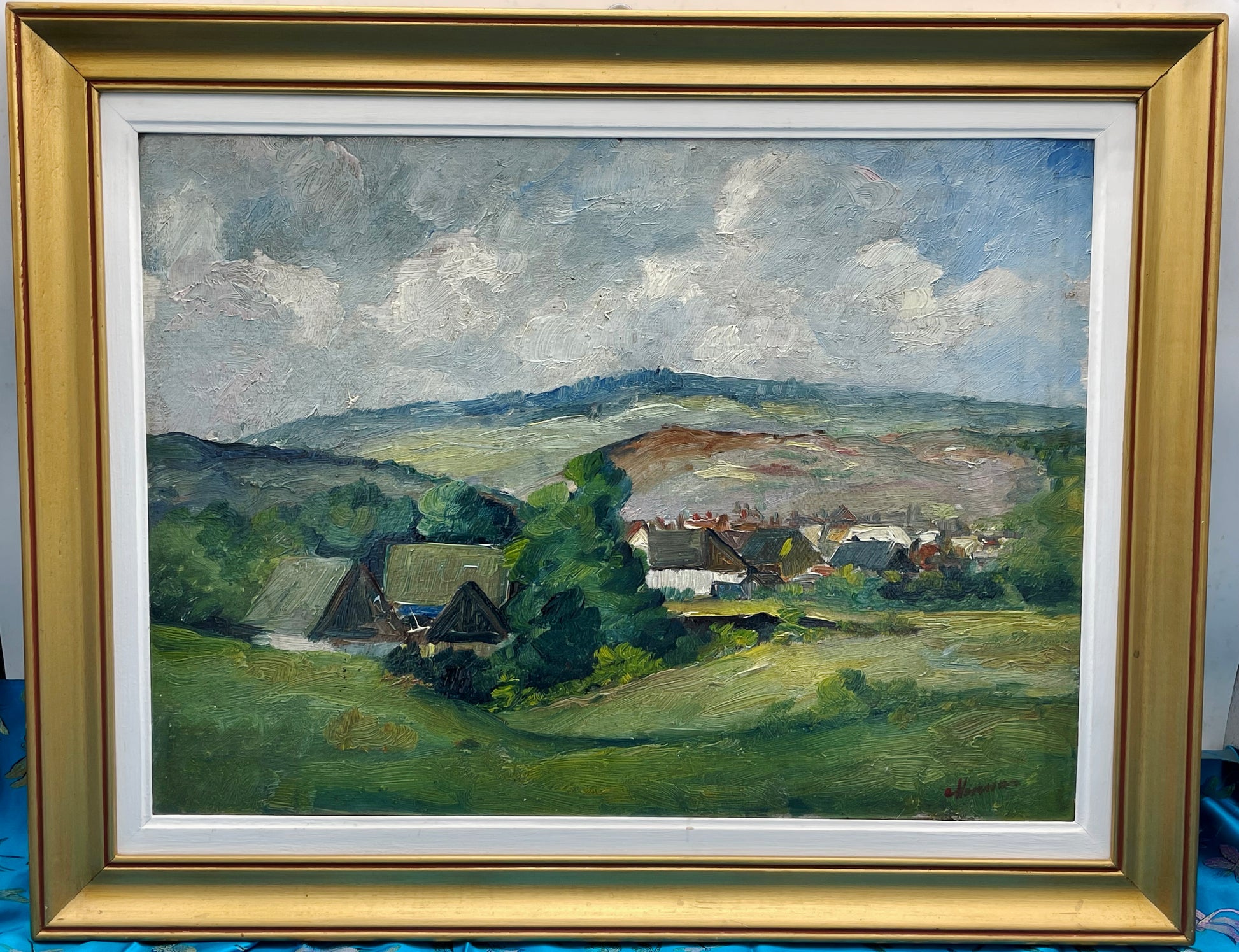 Signed Romanian oil landscape “Harsia” of a Carpathian village, framed in gold and white, straight-on view