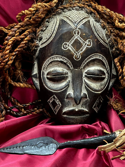Mid-20th Century Chokwe Mask with Raffia Braids and Ceremonial Iron Arrow – Likely Congo