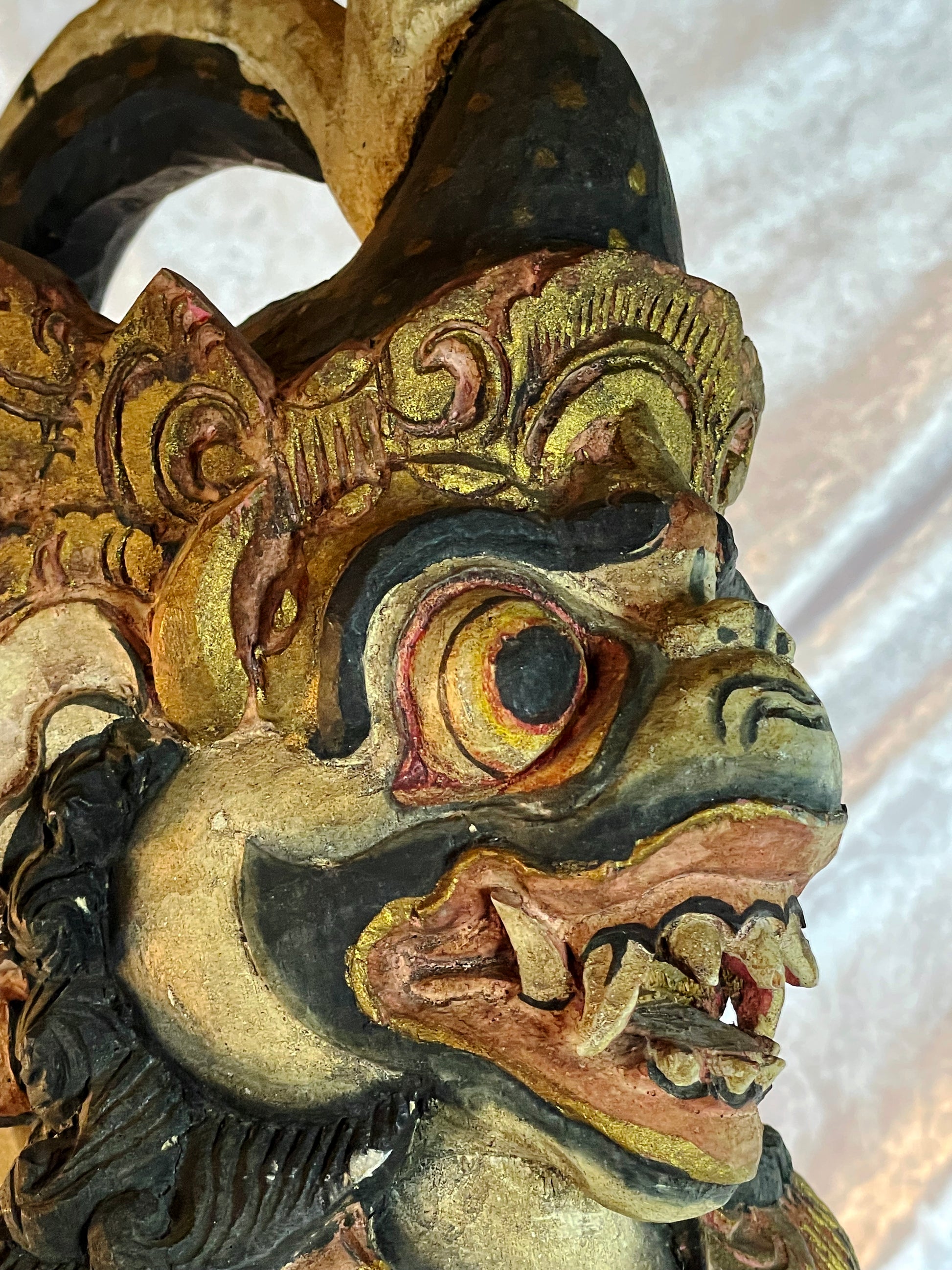 Lower body detail with sacred black and white poleng cloth and lotus base