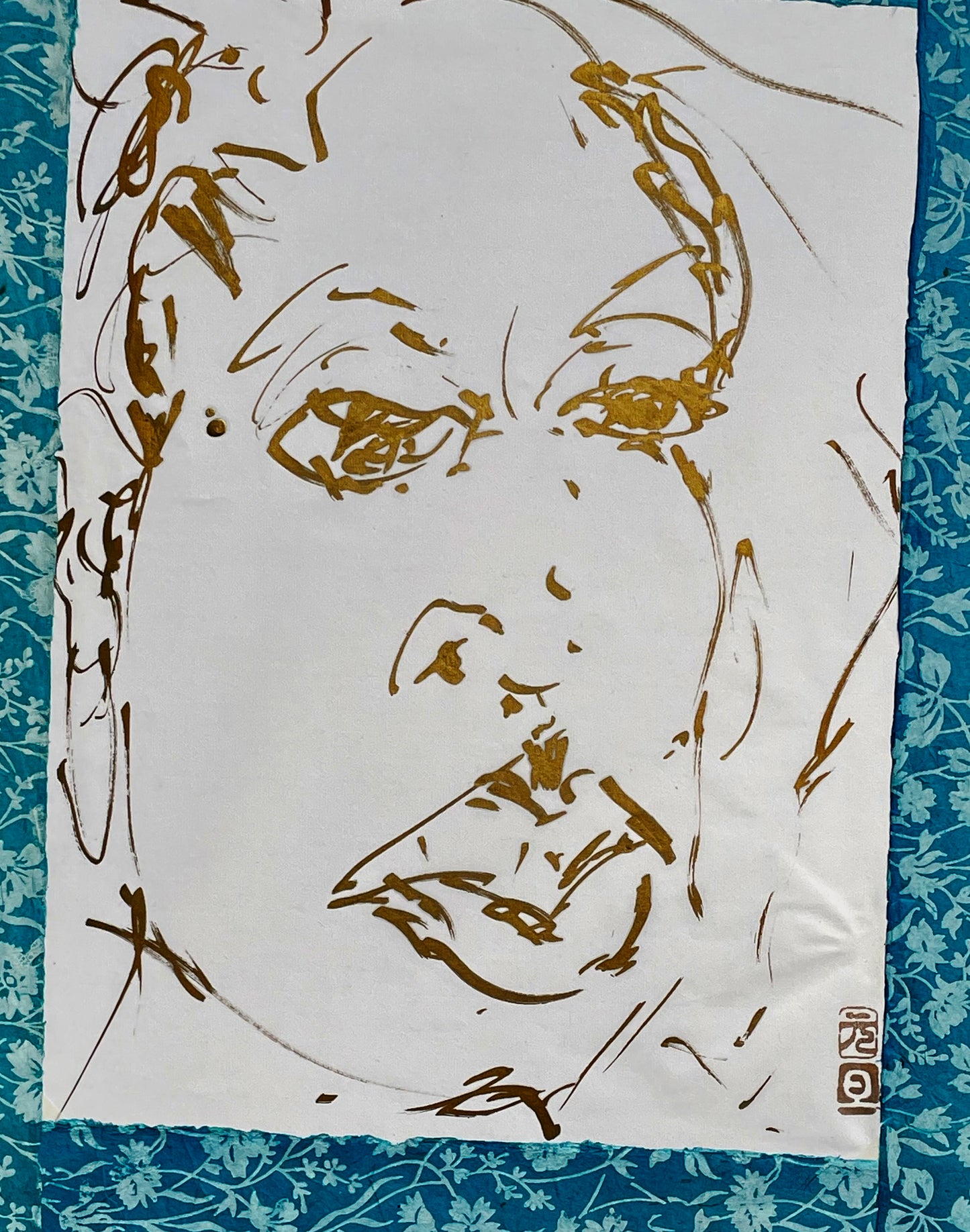 Close-up of the gold-ink portrait showing the brushed facial features