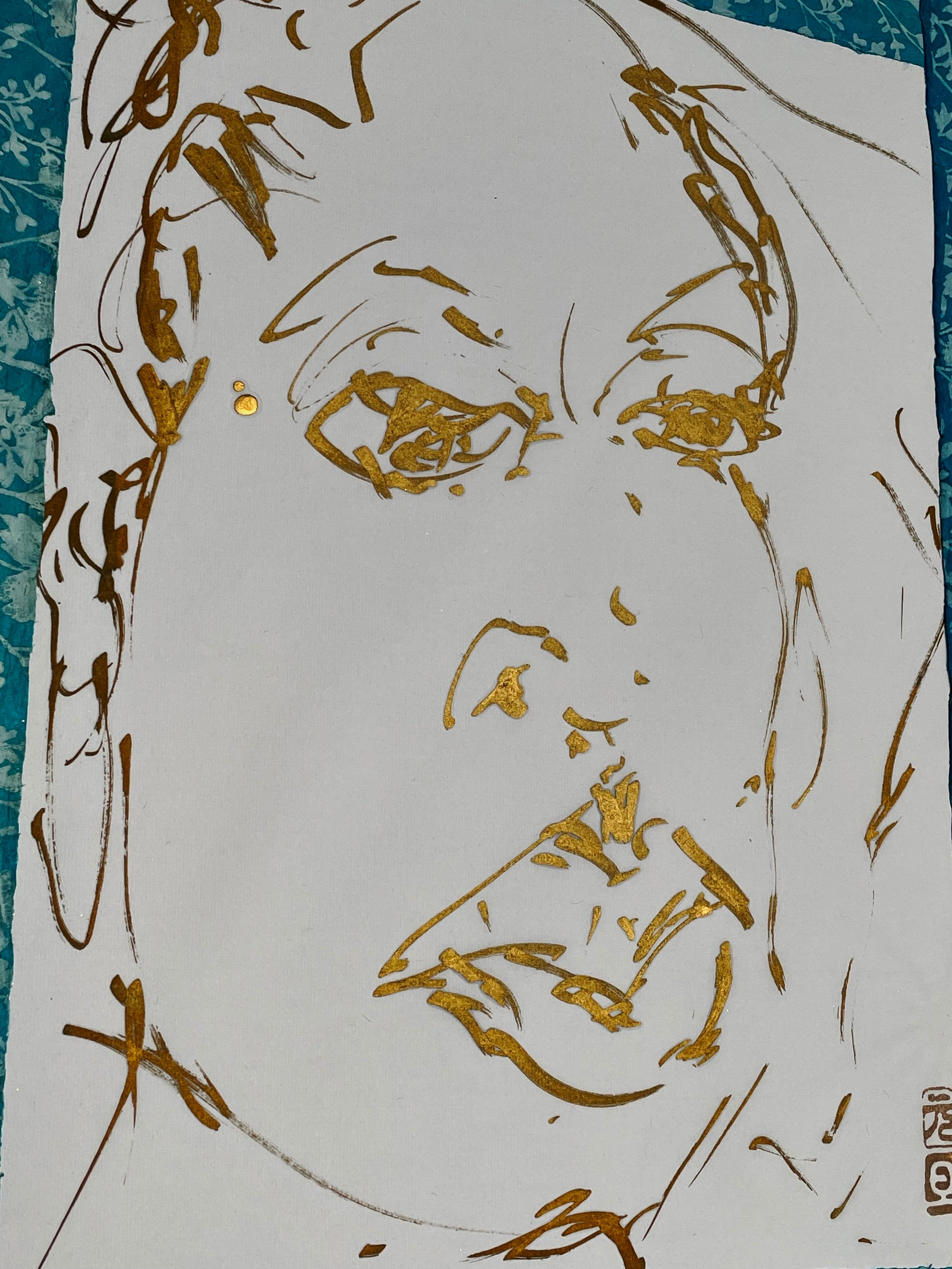 Macro detail of the metallic gold ink texture on the paper