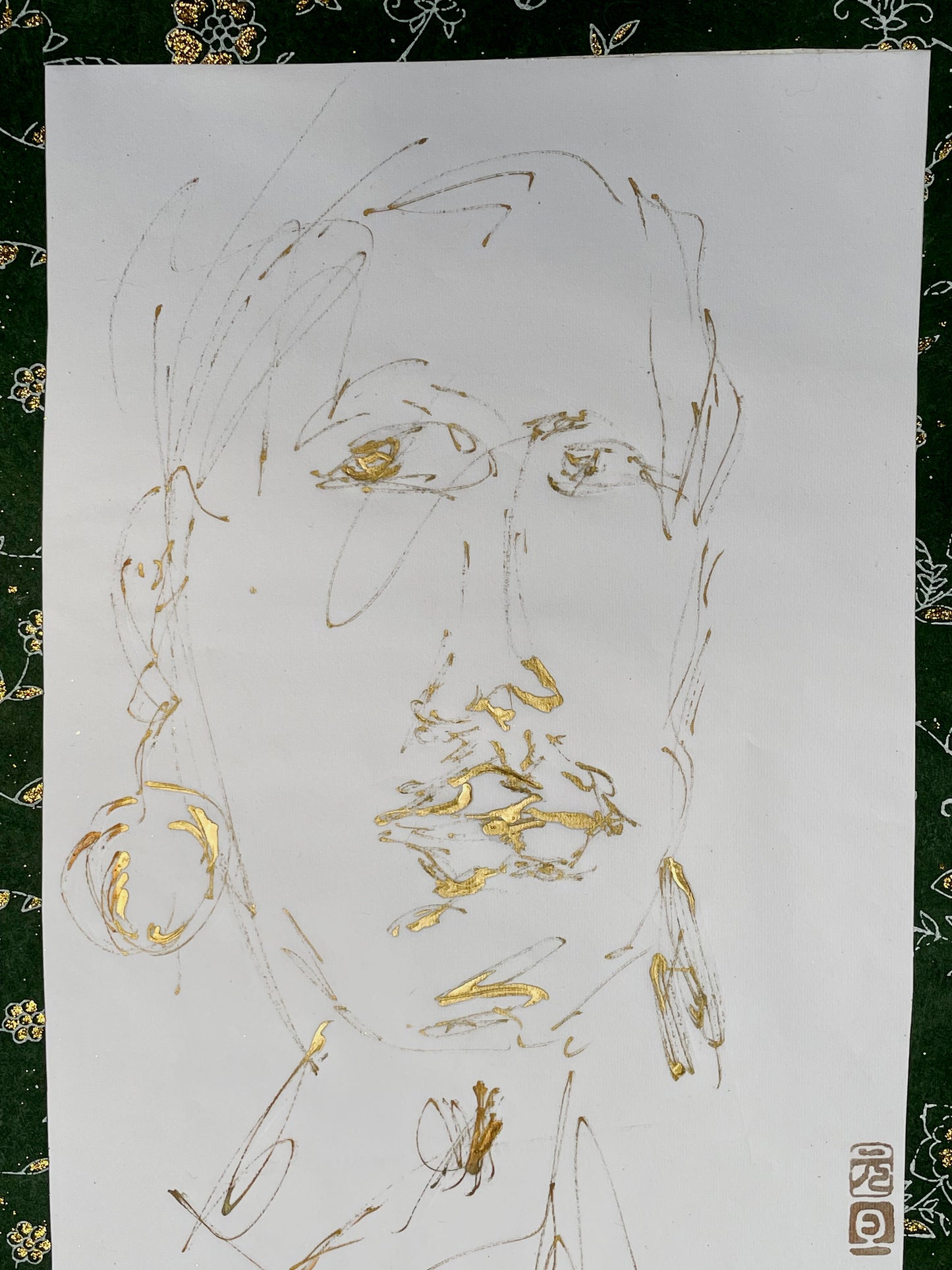 Detail of gold-ink portrait showing brilliant gold lips and hooped earring