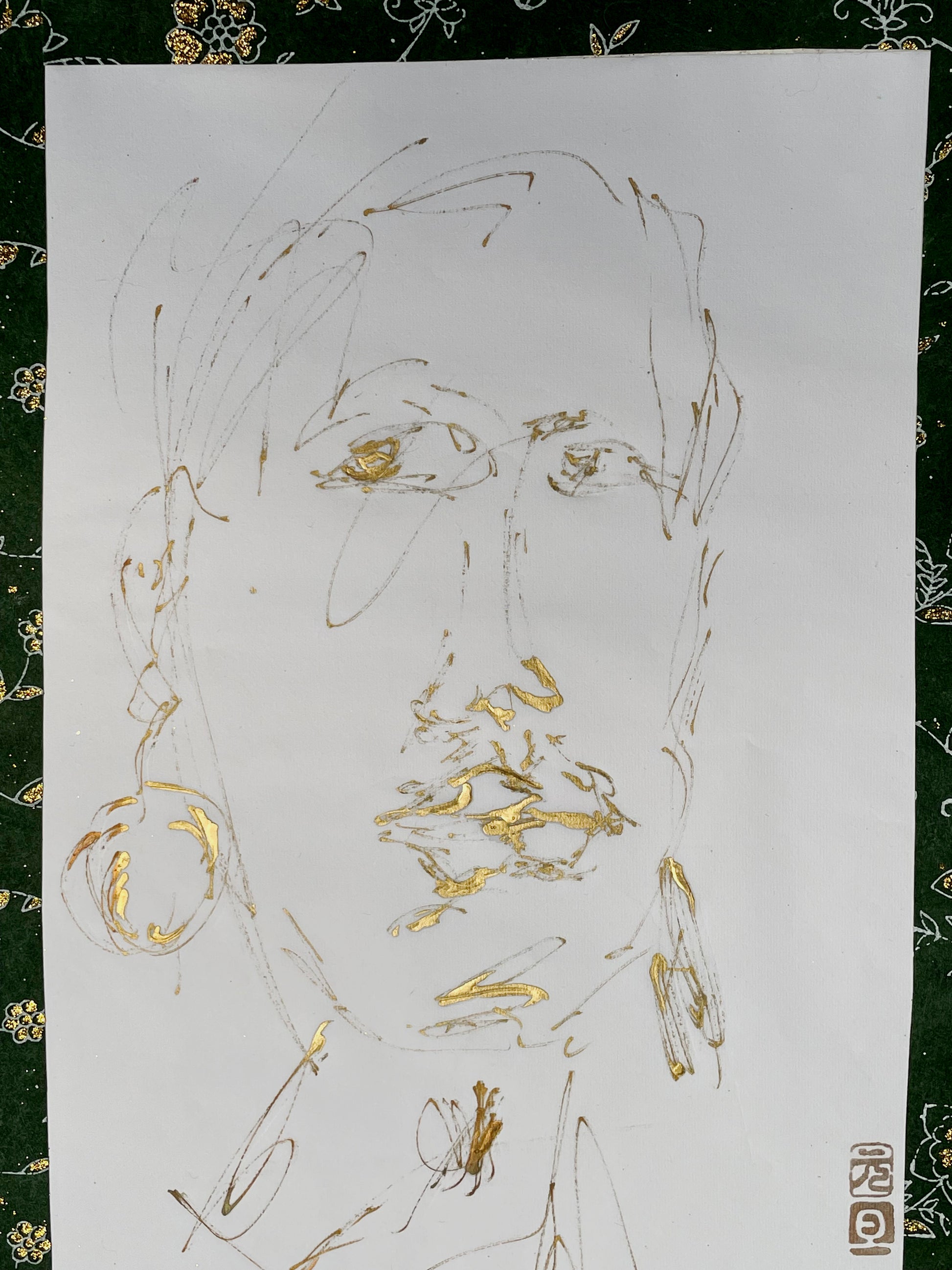 Detail of gold-ink portrait showing brilliant gold lips and hooped earring