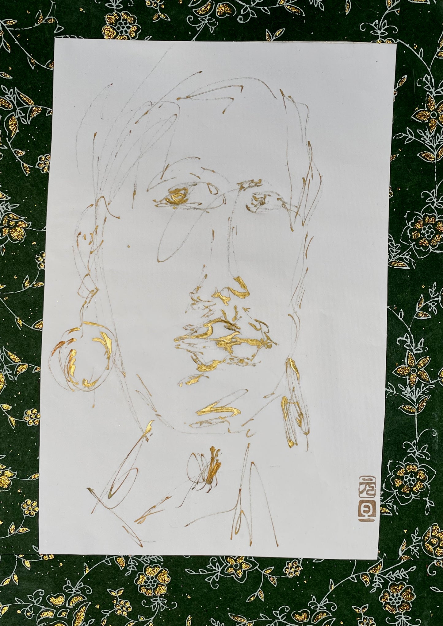 Full view of gold portrait drawing on paper showing loose expressive line work