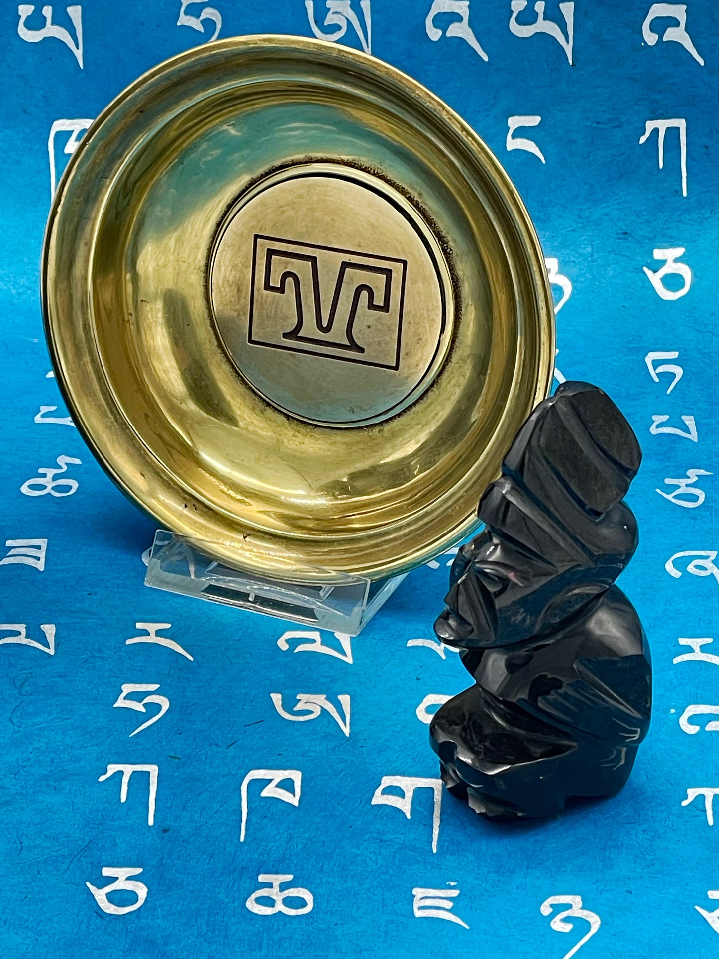 Carved obsidian-like black stone figure profile