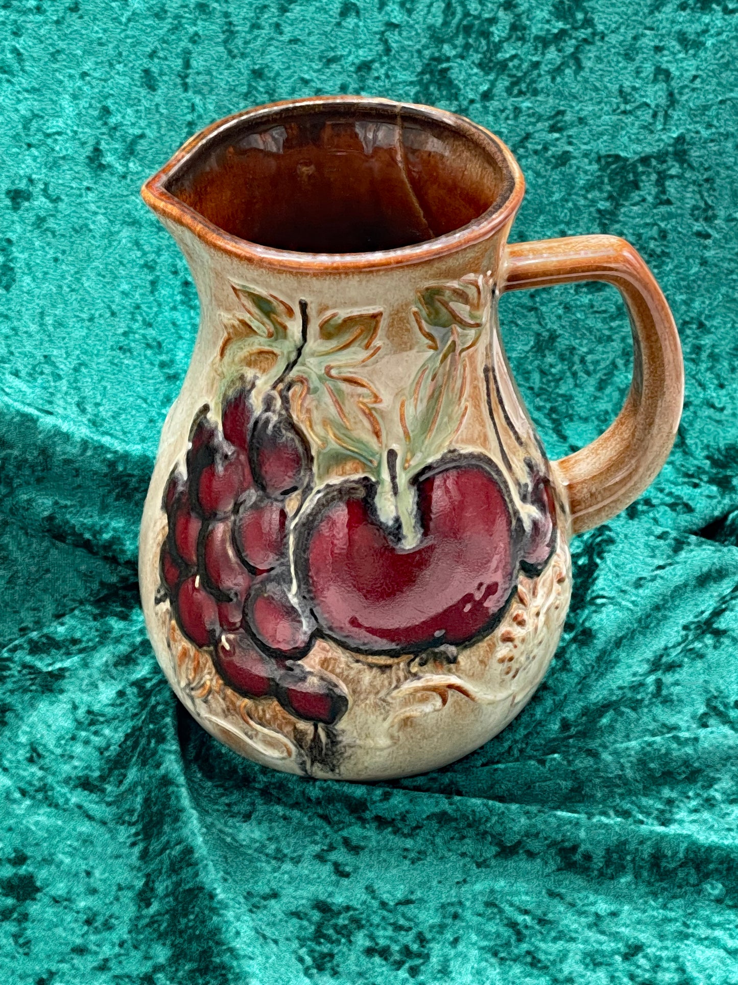 Decorated side of the West German ceramic wine jug showing the glazed brown spout and rim