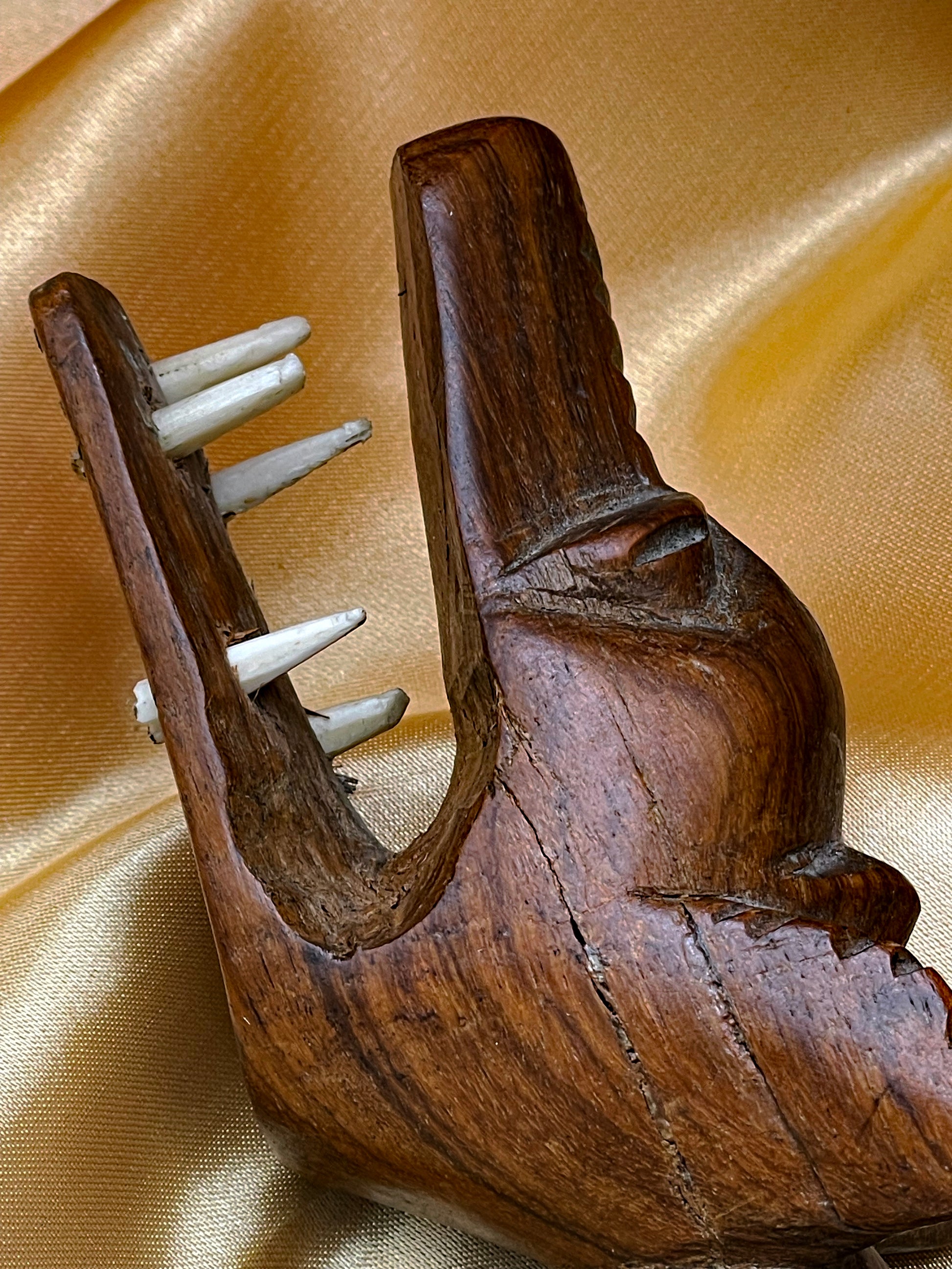 Carved African wood mask with inlaid star and triangle motifs