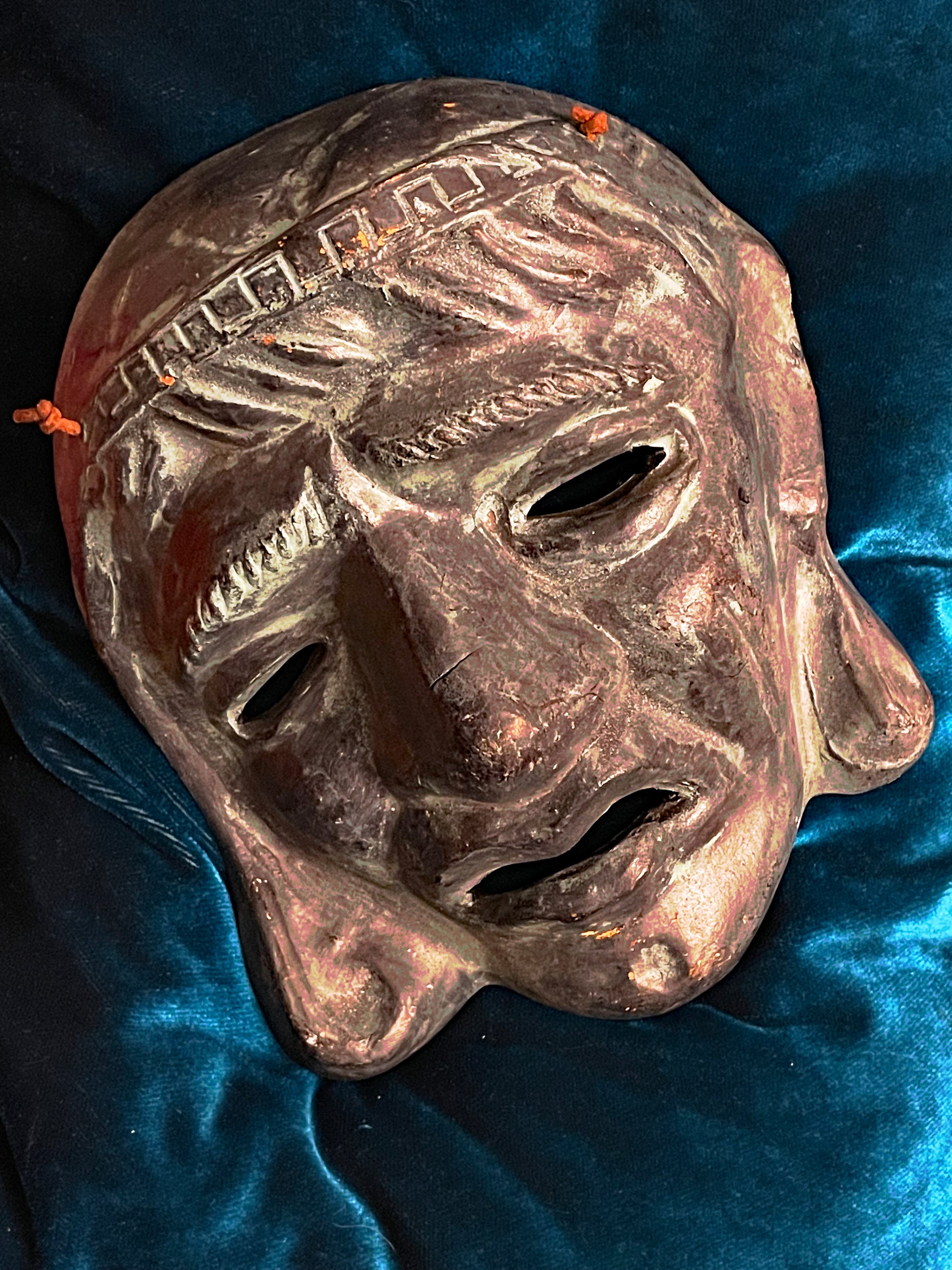 Greek terracotta theatre mask side profile detail