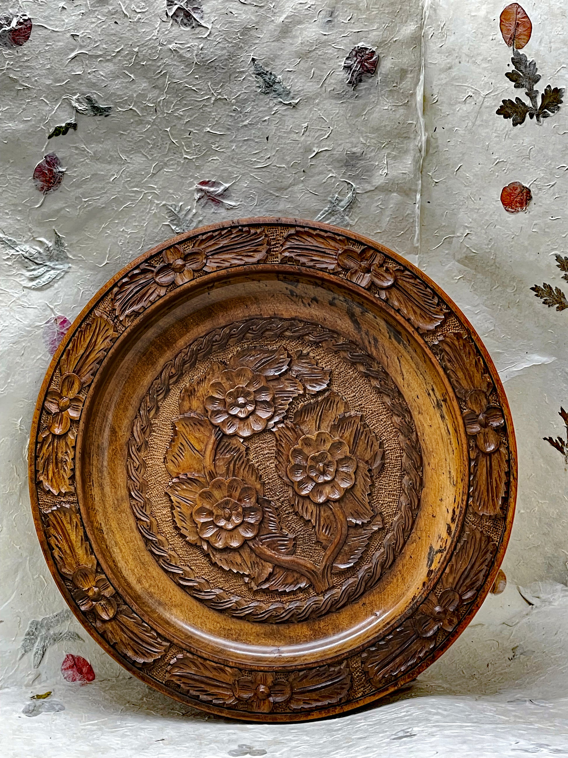 Detail of carved floral relief on antique wooden plate