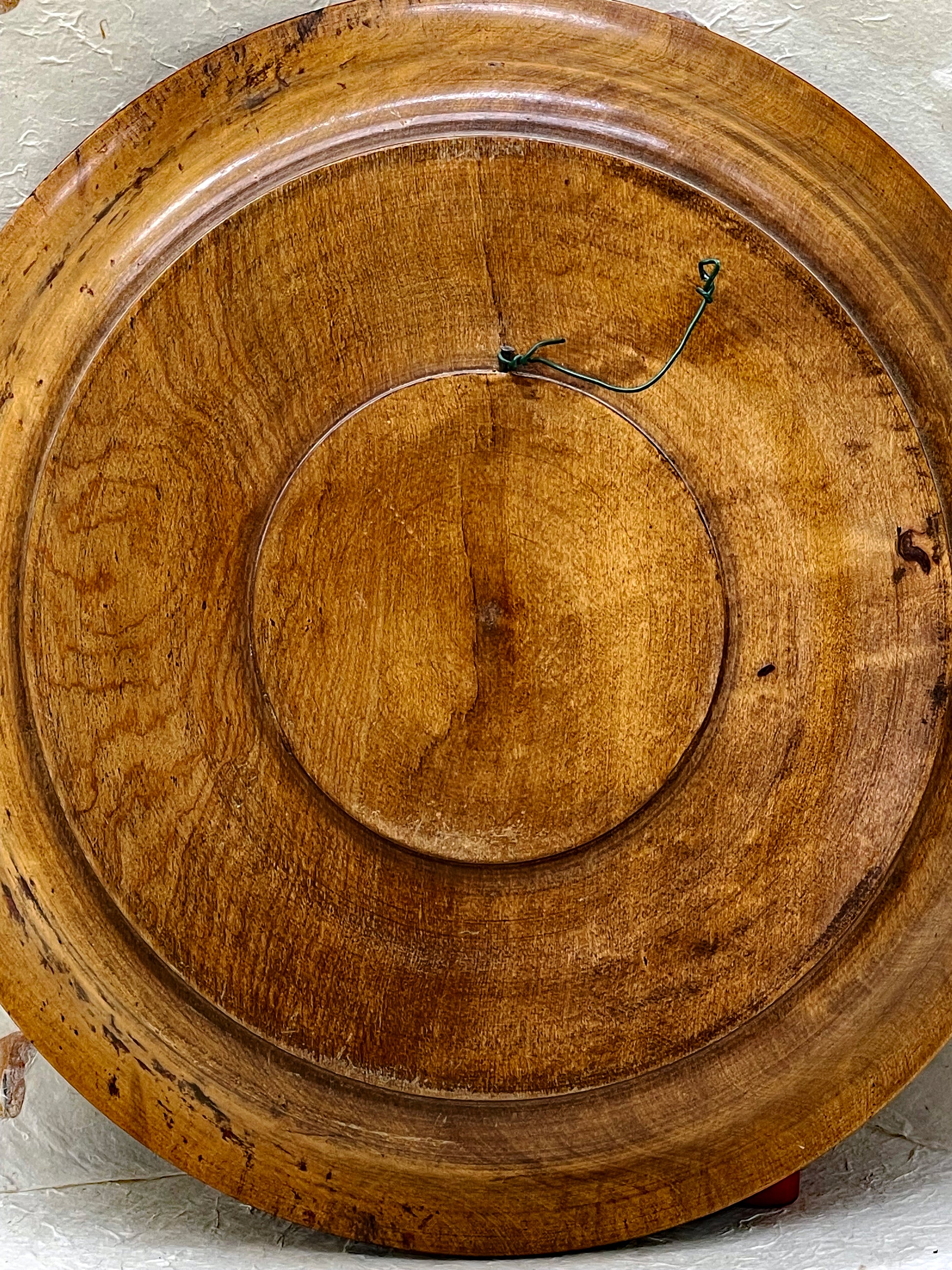 Angled view of carved wooden floral plate