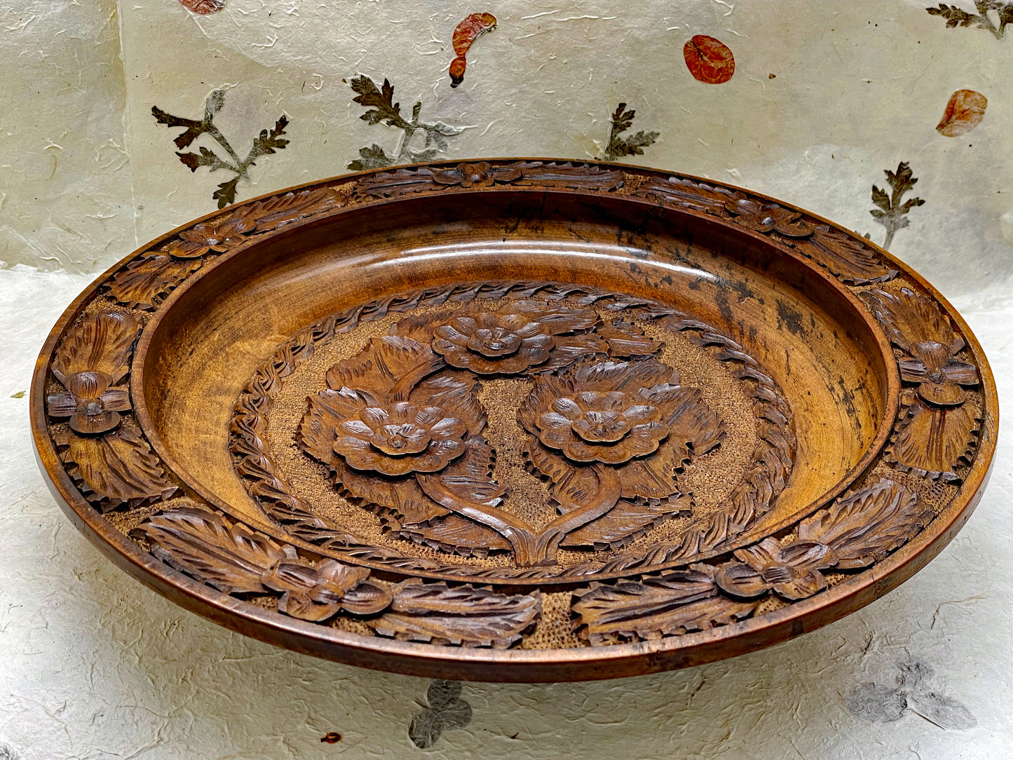 Large hand-carved wooden collector's plate with floral relief carving
